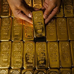 A%20person%20holding%20a%20gold%20bar%20among%20rows%20of%20gold%20bars,%20each%20marked%20with%20%271000g%27%20and%20%27999.9%27.