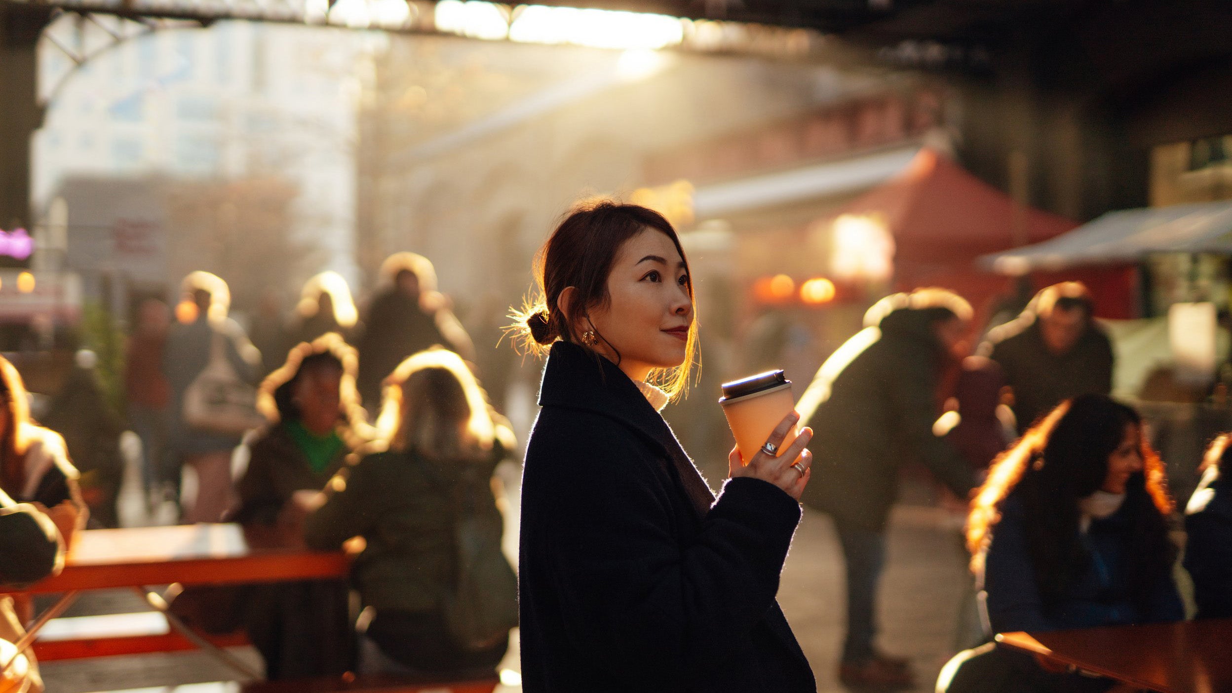 Young Asian woman looking for lunch ideas at local food market.