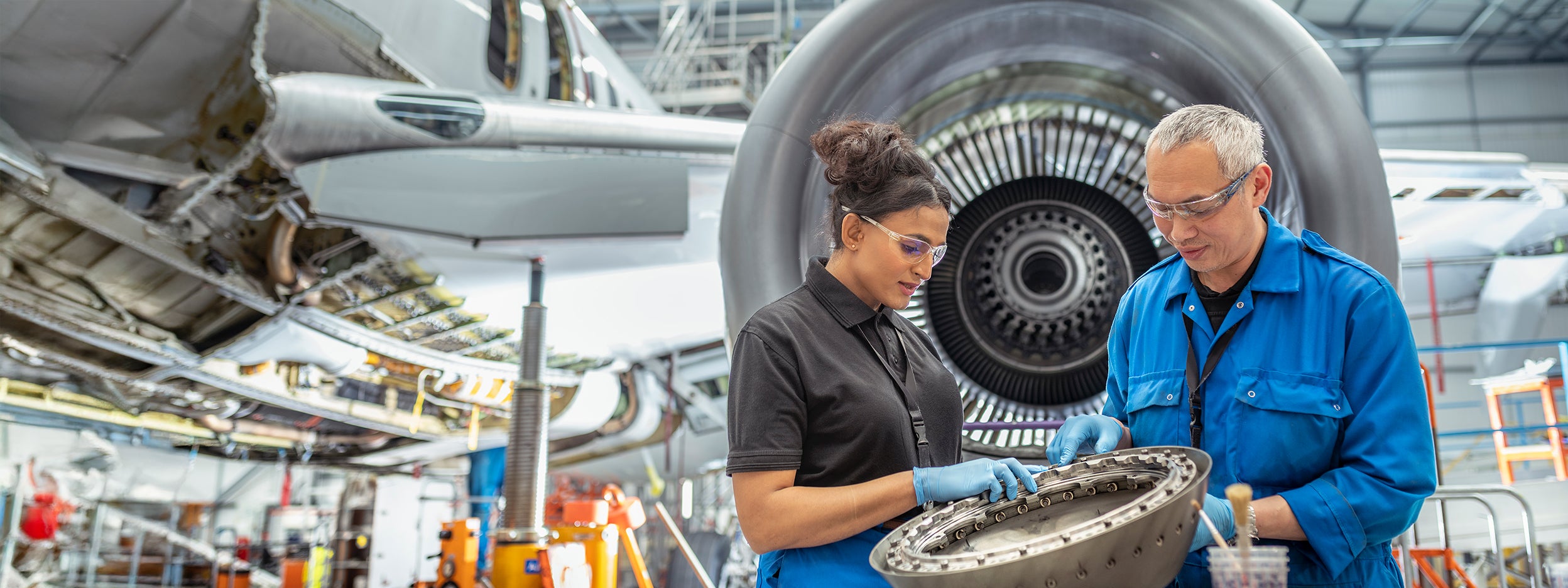 Engineers working on a plane engine