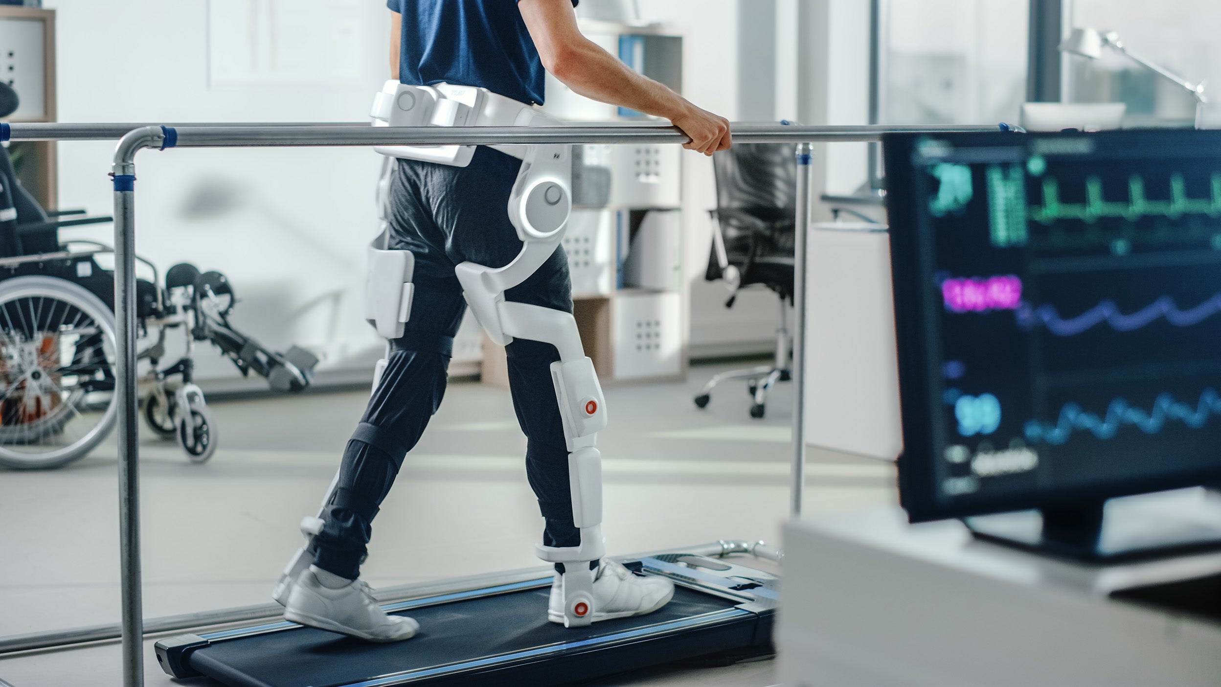 person walking on treadmill with robotic technology
