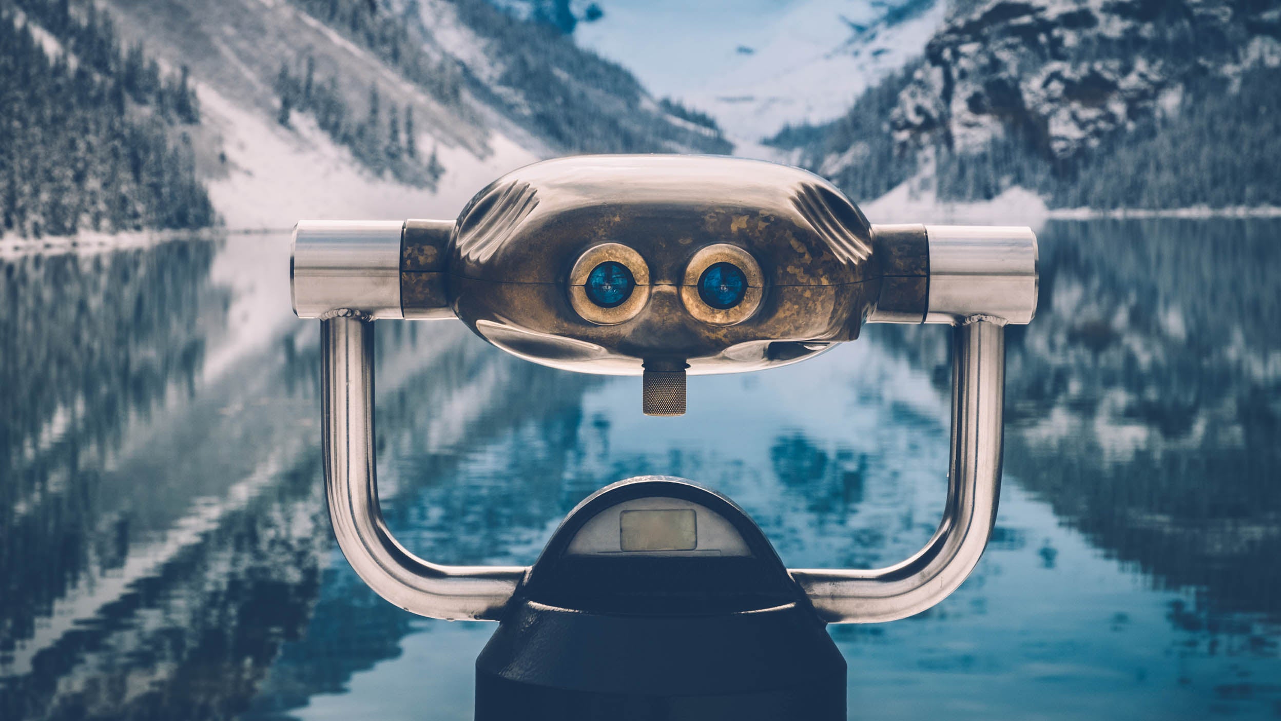 A viewfinder in front of the beautiful mountain scenery of Lake Louise in winter