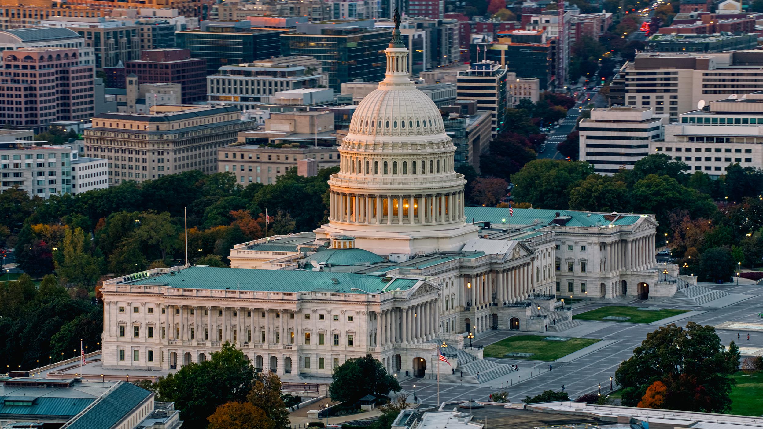Helicopter shot of the Capitol Building in Washington, D.C. at sunset.