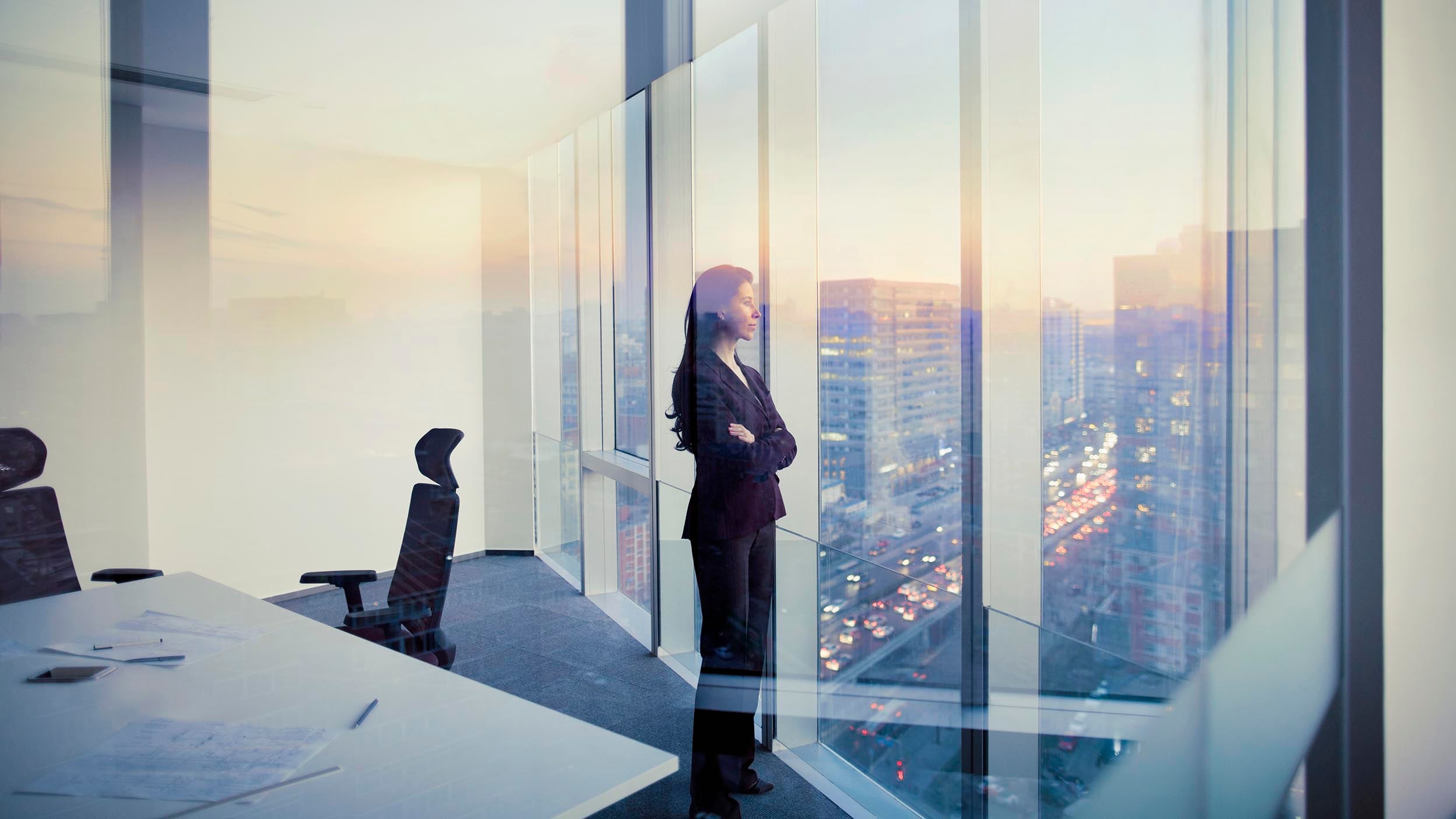 Woman looking out of a conference room window