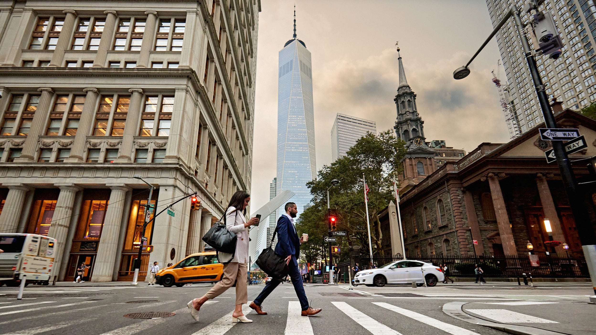 A man and woman walking on the pedestrain way.