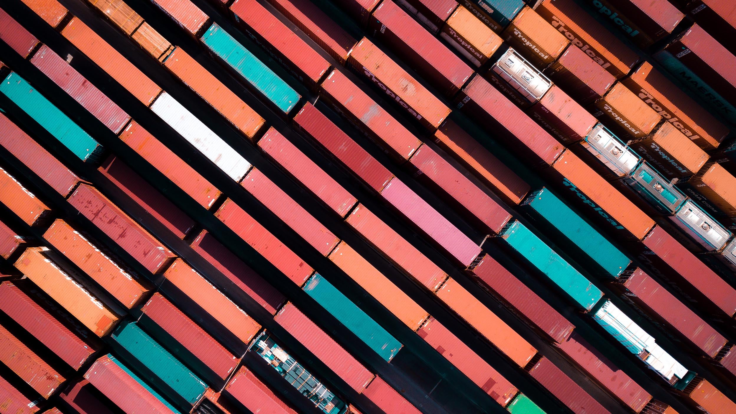 Aerial view of cargo boxes in a shipyard and dock