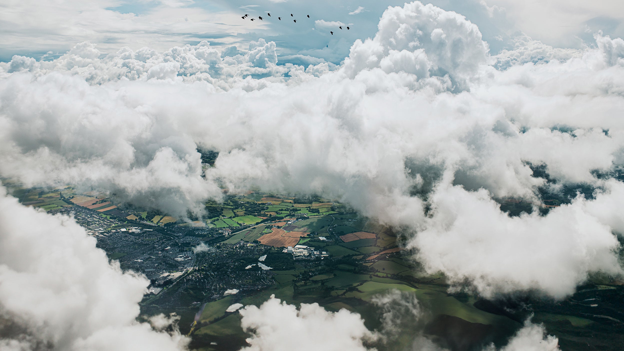 View from above the clouds of green landscapes.