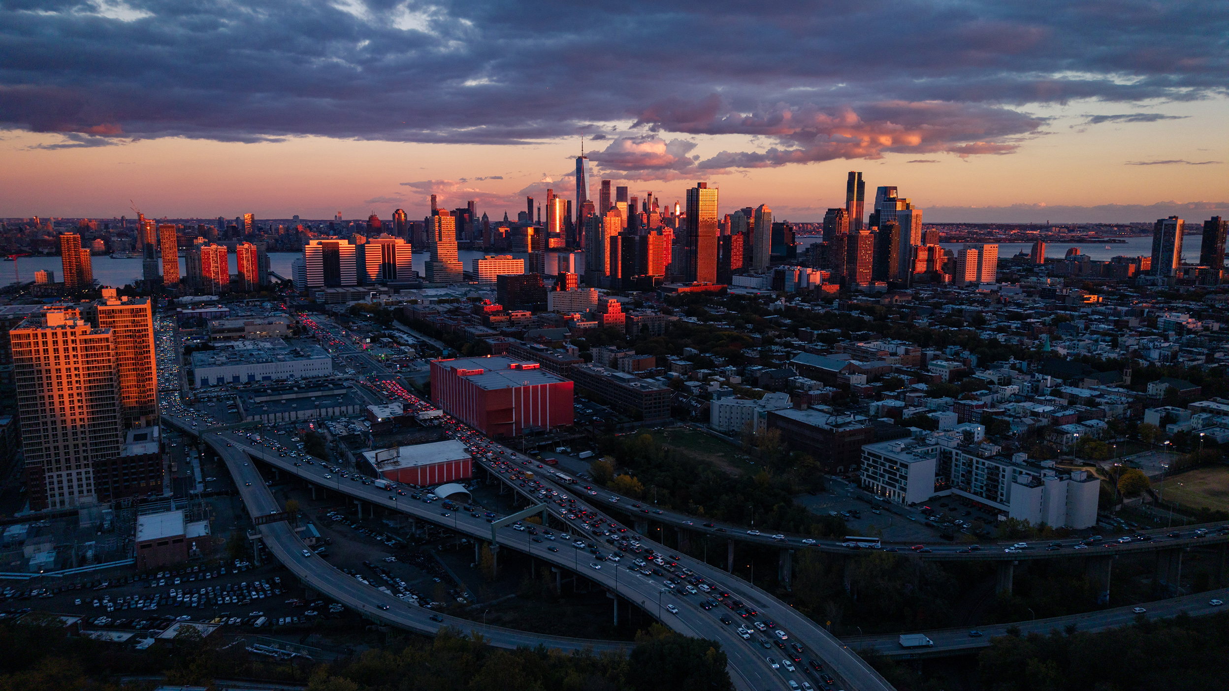 Jersey City skyline at sunset with highway traffic