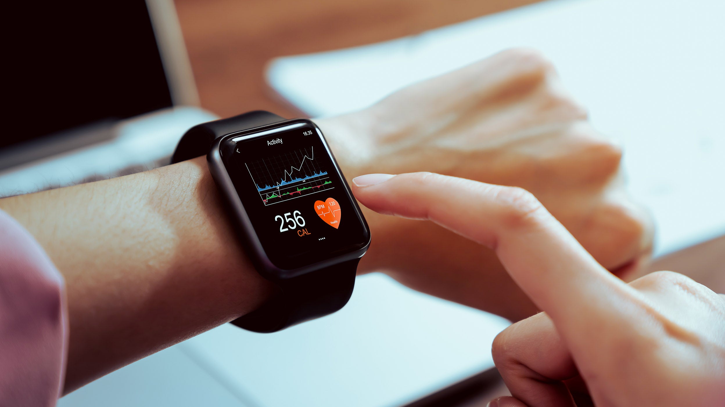 Close up of hand touching smartwatch with health app on the screen, gadget for fitness active lifestyle.