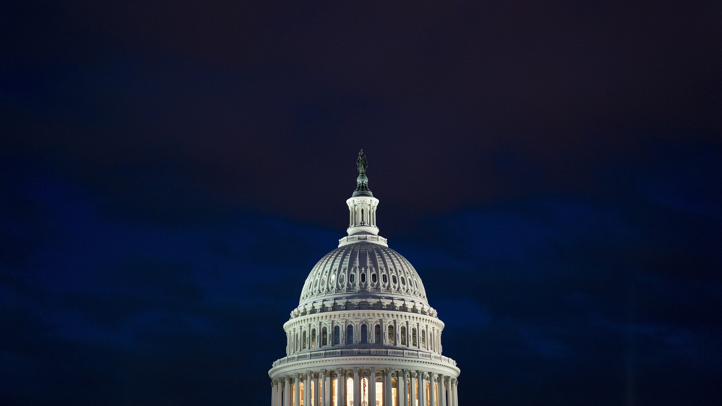 The U.S. Capitol building illuminated against a dark sky in Washington, D.C.