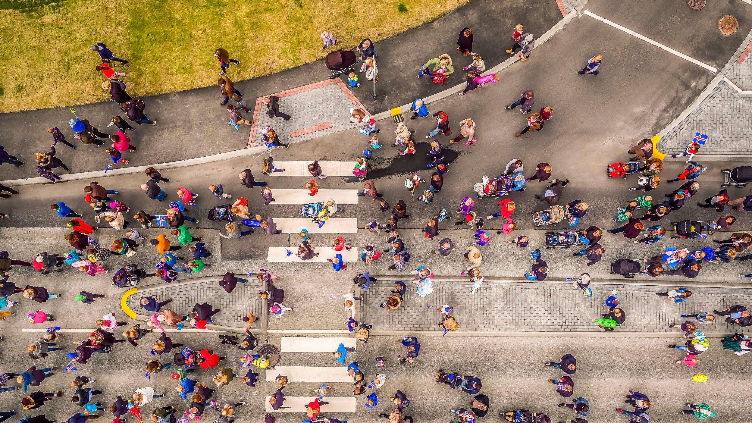 Aerial view of people on the street, with a street dividing into two.