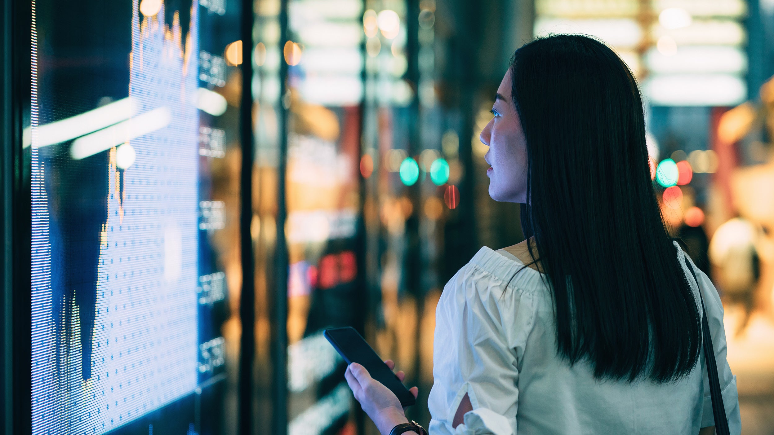 Woman looking at stock market data