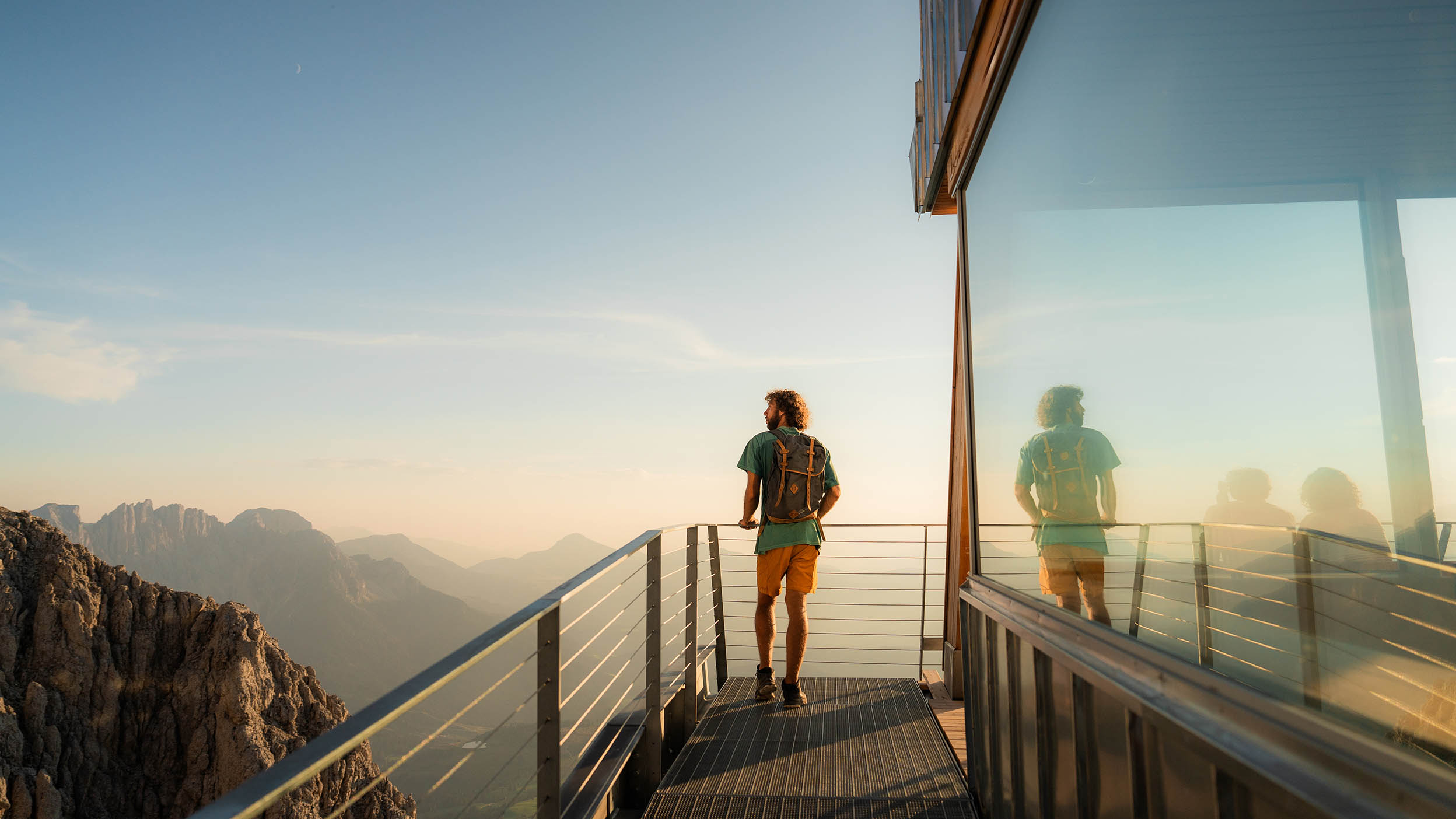 Man standing on a balcony in the mountains