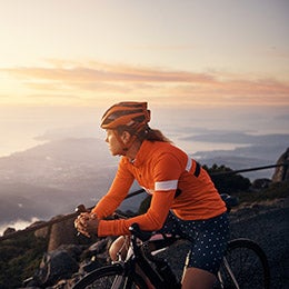 Woman%20on%20bicycle%20looking%20at%20sunset.
