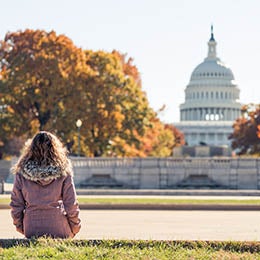 A%20woman%20in%20a%20coat%20looking%20at%20the%20US%20Capitol%20Building