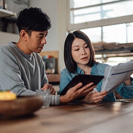 Asian%20couple%20going%20over%20taxes%20on%20their%20tablet.