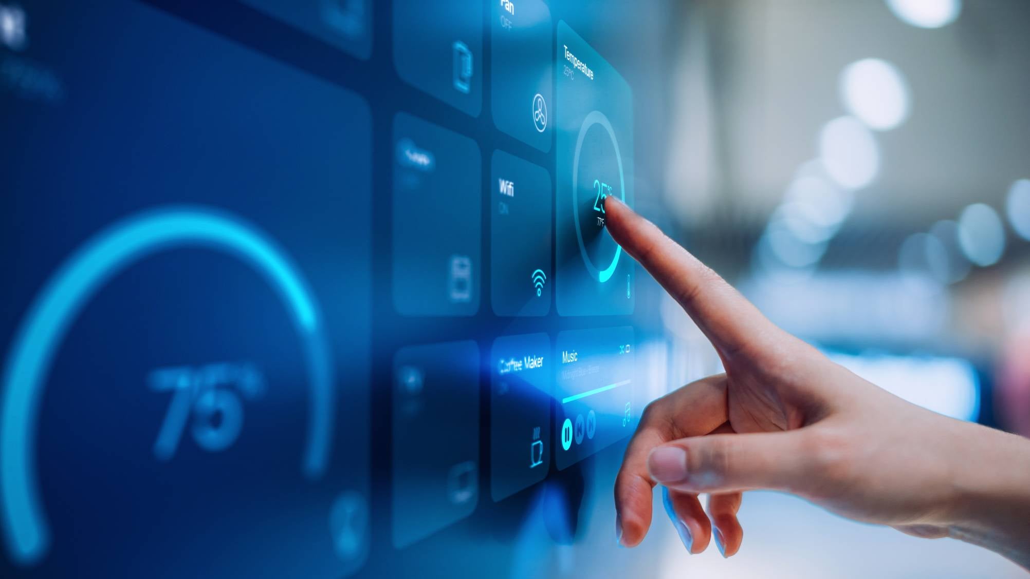 Close up of woman's hand setting up intelligent home system, controlling smart home appliances with control panel of a smart home.