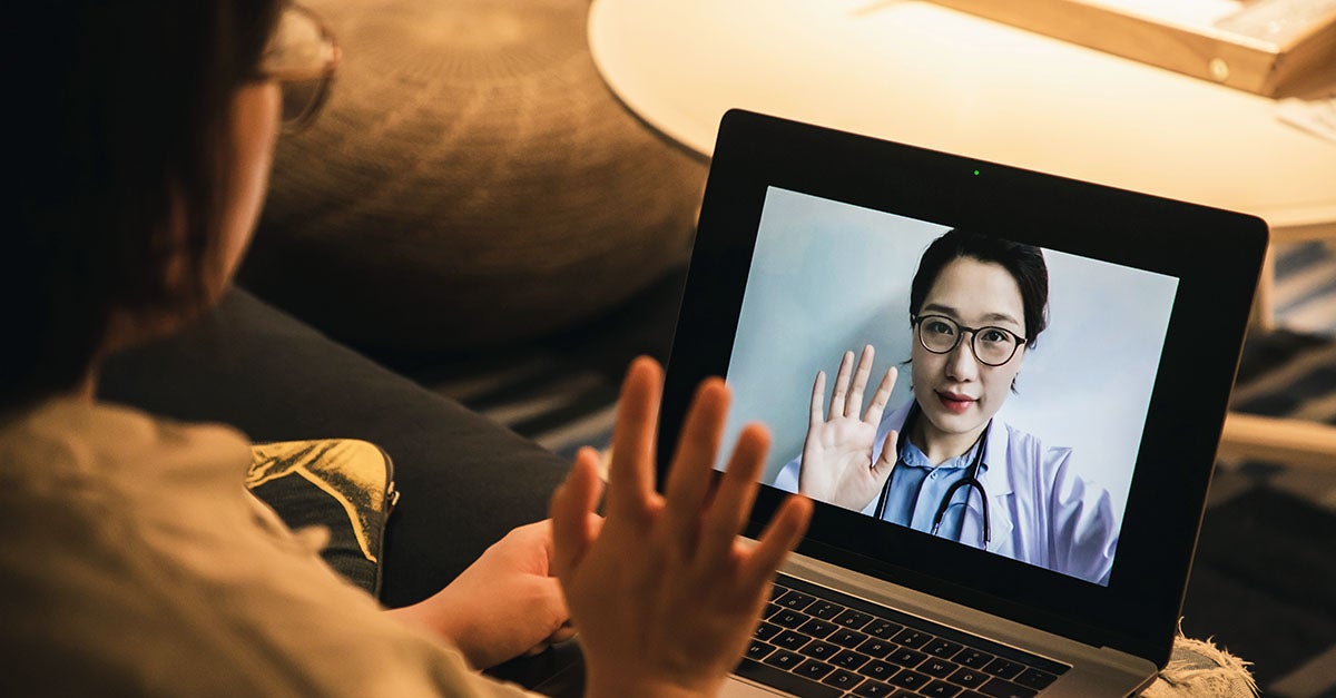 Consulting asian doctors online using laptop