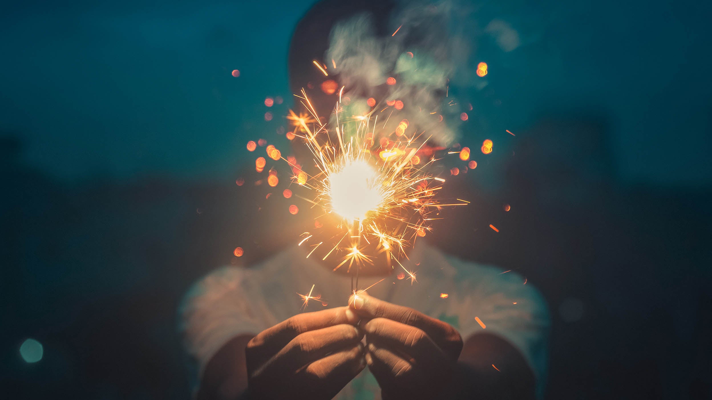 Person pictured holding a sparkler in celebration. Invesco QQQ congratulates and welcomes the newest additions to the Nasdaq-100 Index.