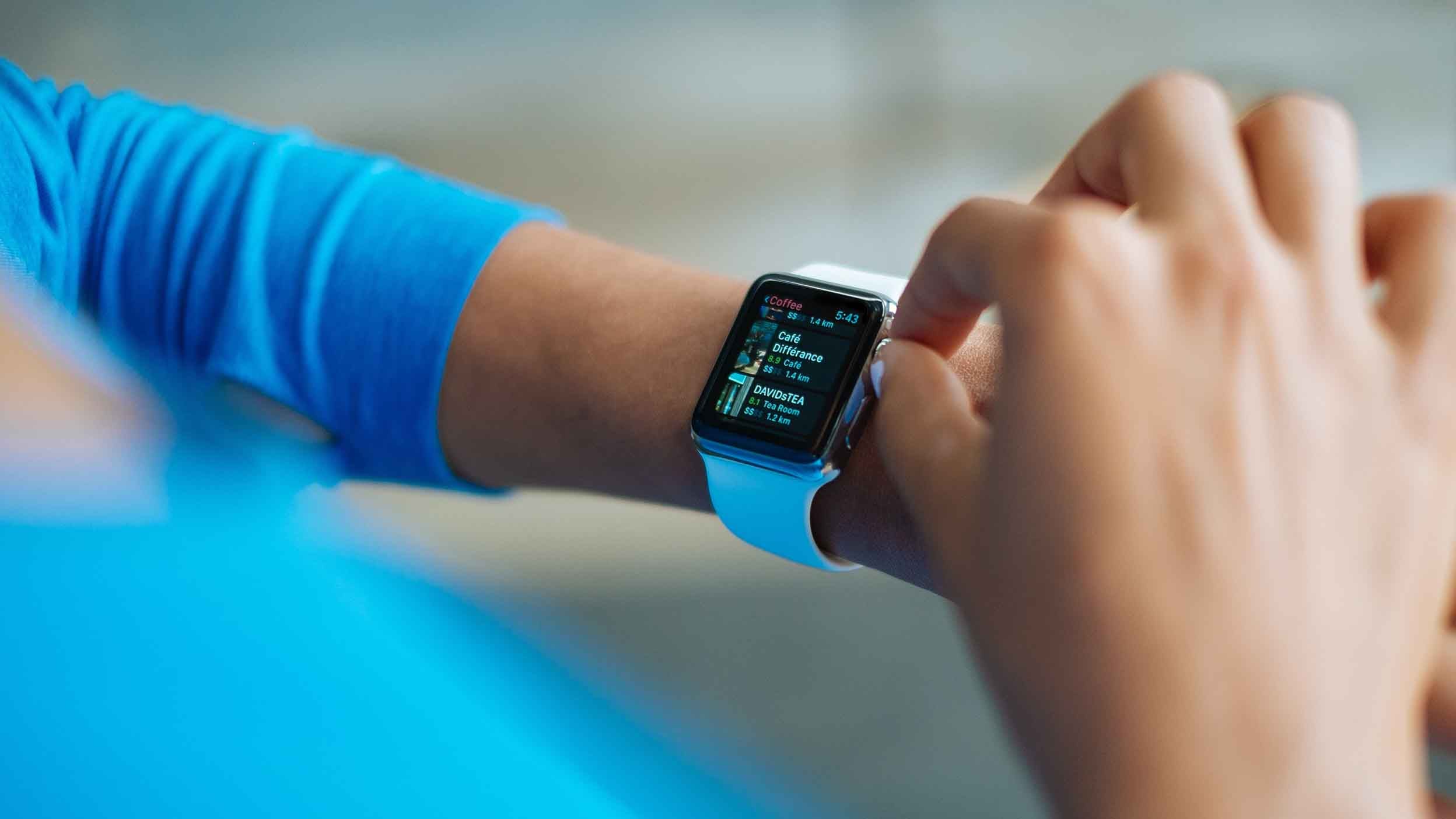 smart watch keeping track of positive investment growth with Invesco qqq
