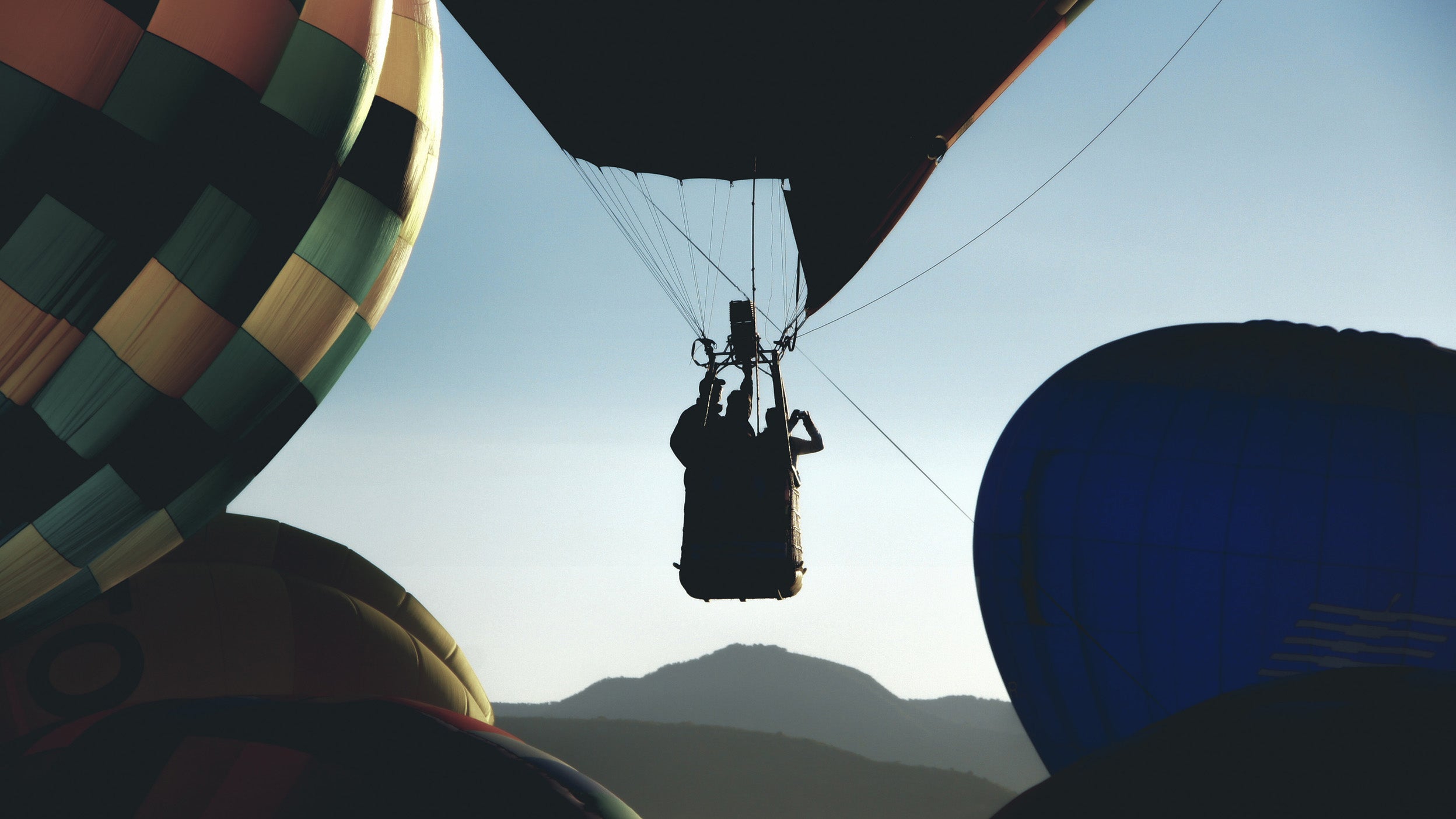 Silhouette of hot air balloon rising