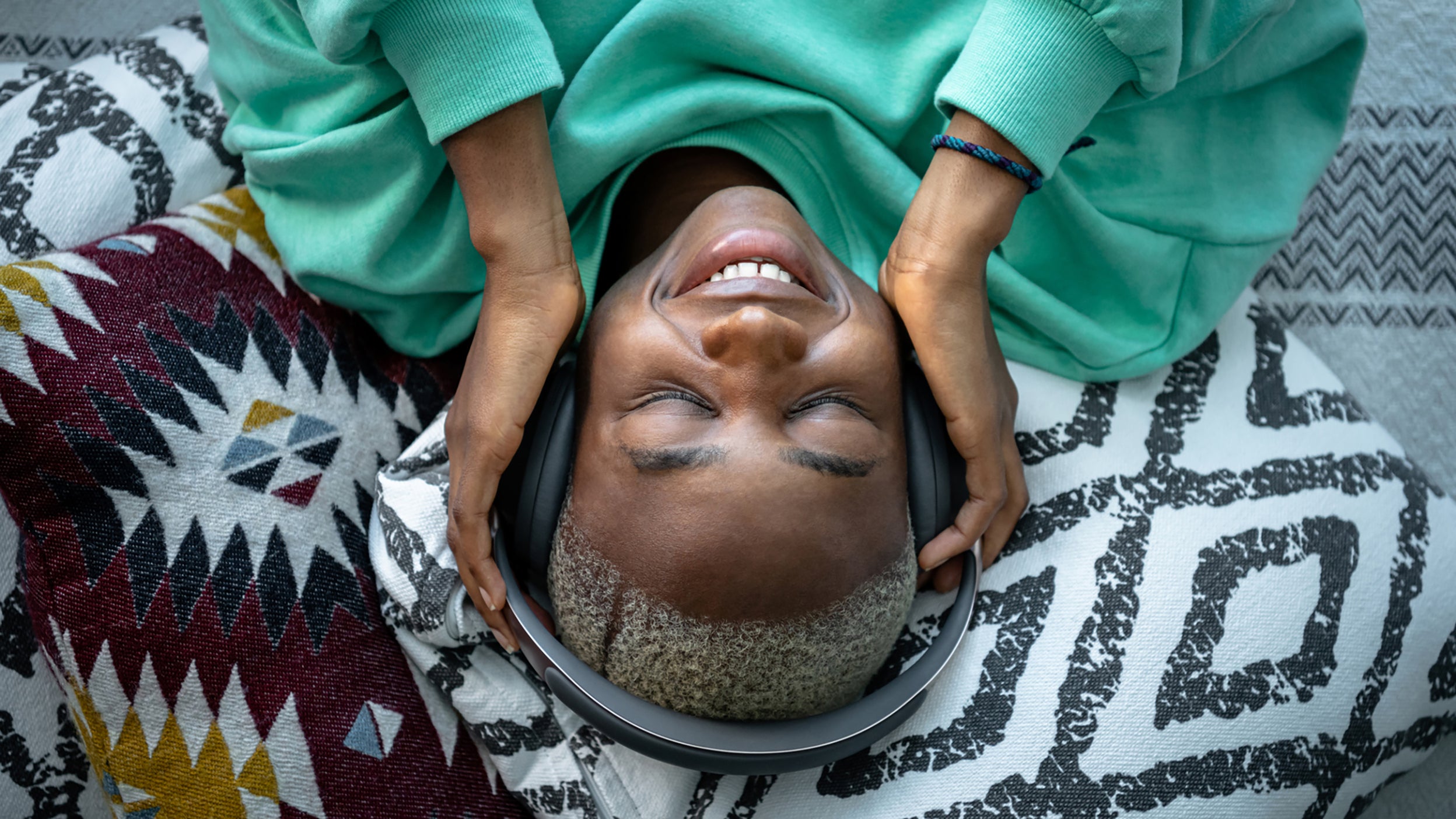 A woman lies down and streams content illustrating innovation in the entertainment sector.