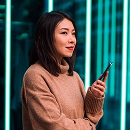 A%20smiling%20woman%20is%20pondering%20the%20Invesco%20QQQ%20ETF%20companies%20that%20are%20helping%20build%20and%20transform%20the%20blockchain%20ecosystem.
