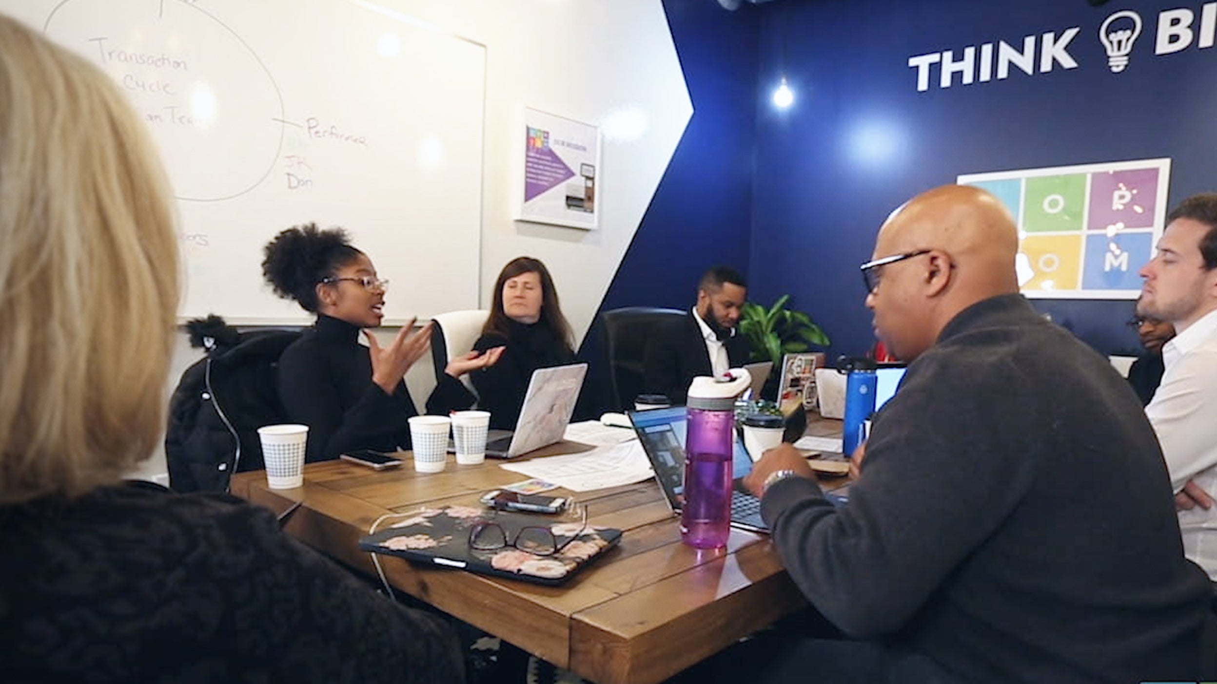 Office meeting with Popcom employees. PopCom is a company featured in Invesco QQQ's Innovation Now series.