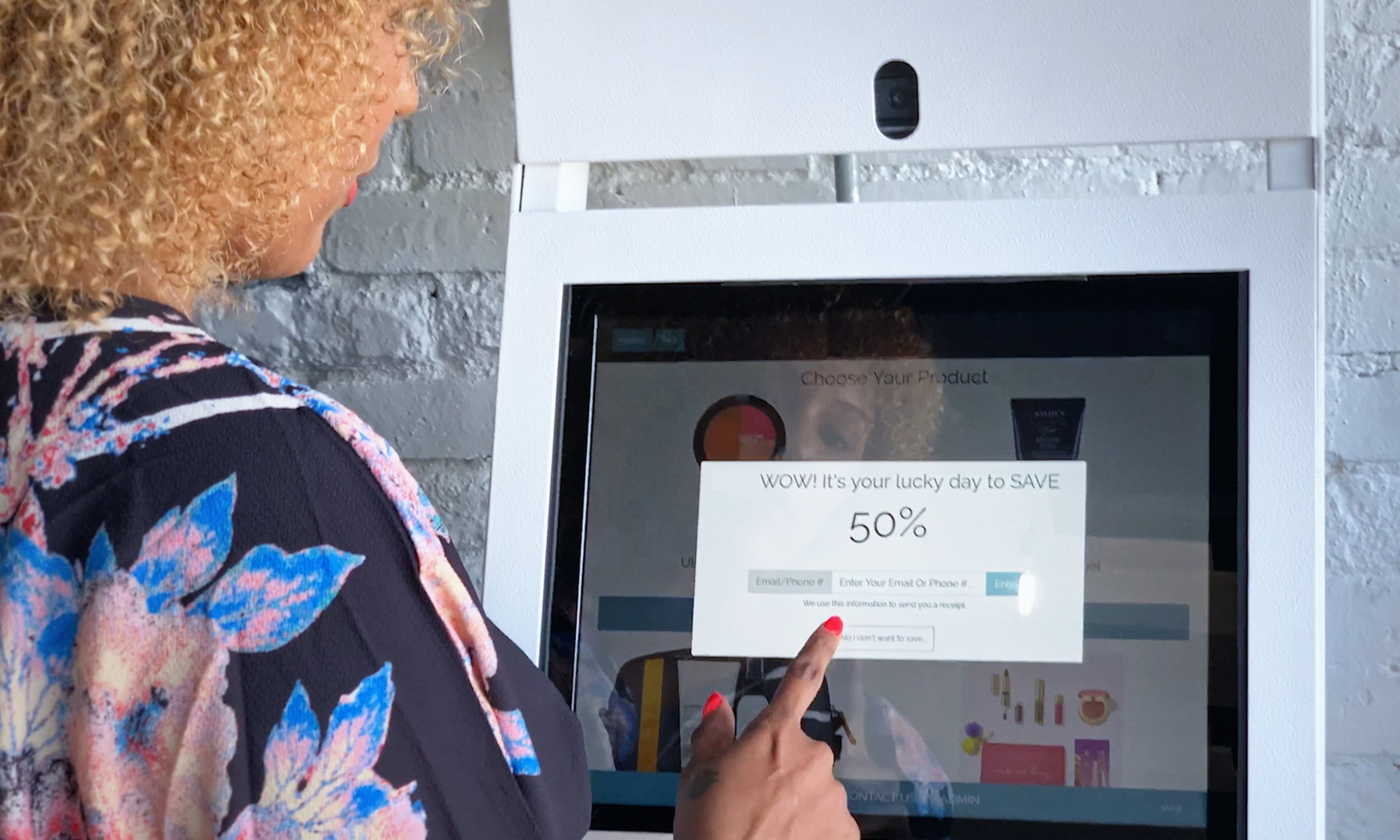 Woman at touchscreen featuring point of sale innovation from PopCom, a company featured in Invesco's Innovation Now series