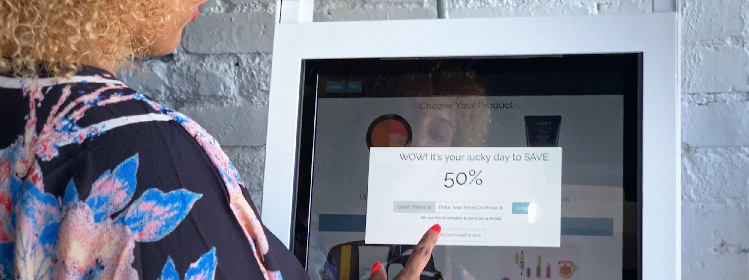 Woman at touchscreen featuring point of sale innovation from PopCom, a company featured in Invesco's Innovation Now series