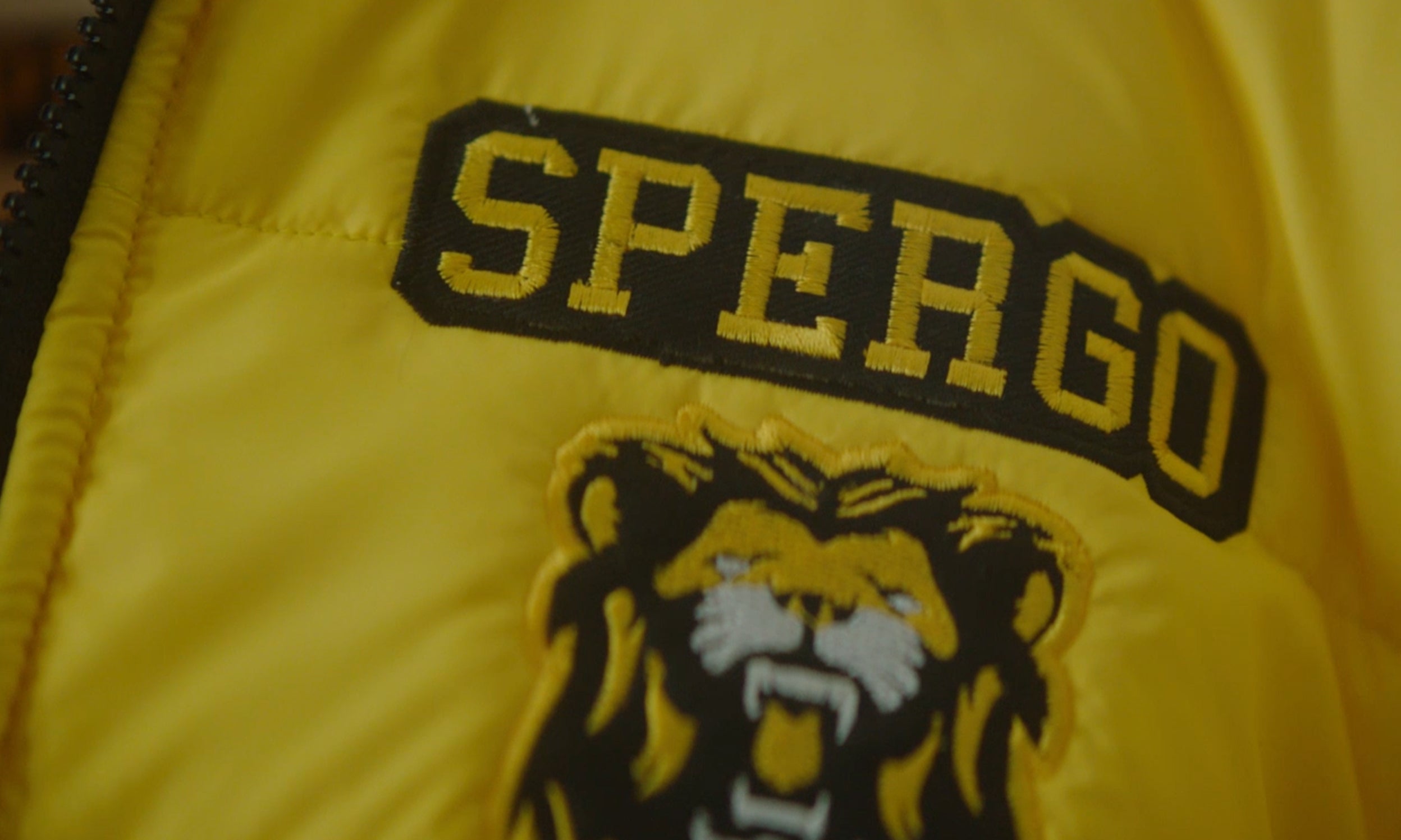 Spergo logo on yellow jacket. Spergo is a company featured in Invesco QQQ's Innovation Now series.