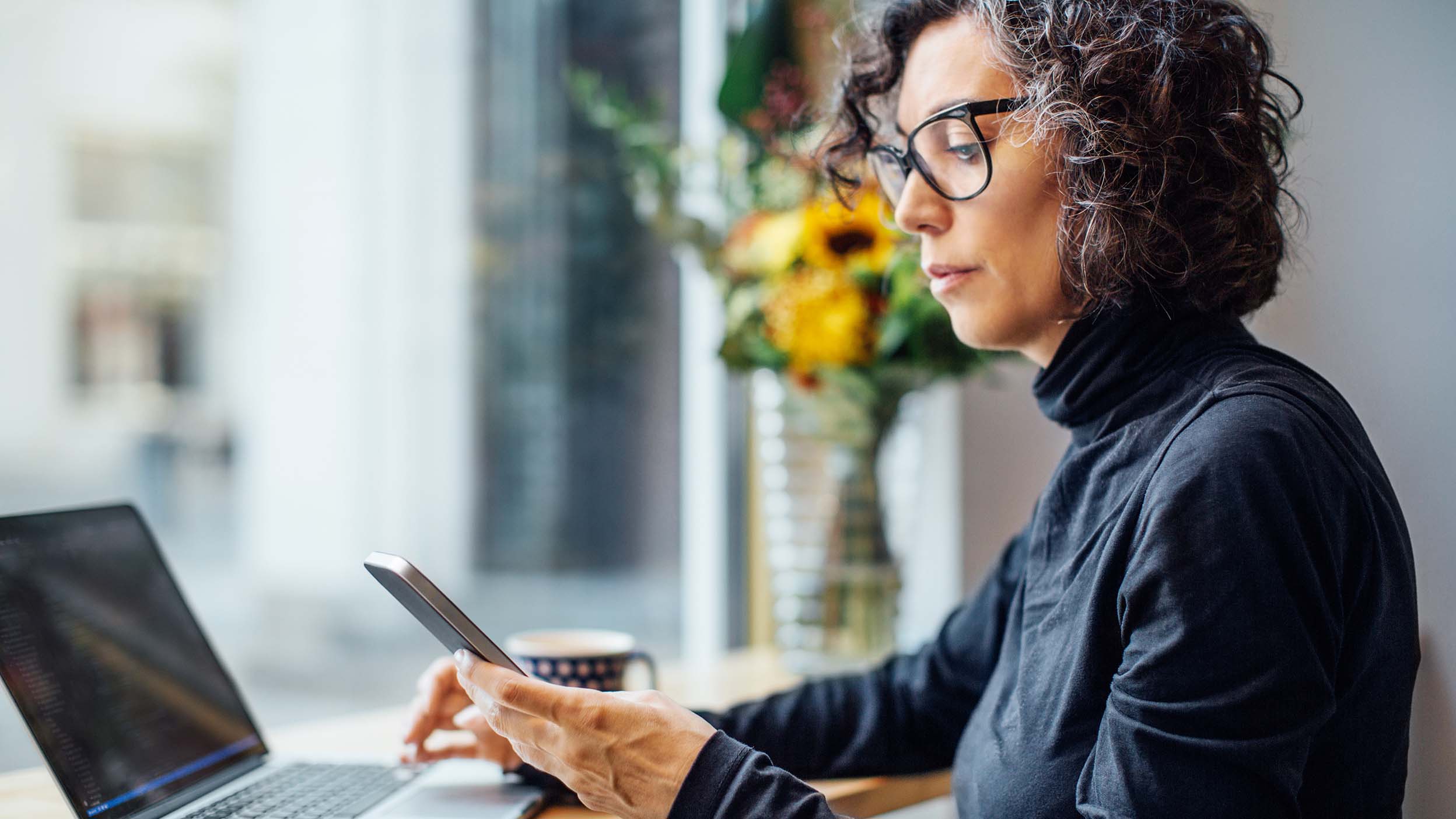 Individual investor working remotely and learning more about the benefits of exchange traded funds like Invesco QQQ ETF.