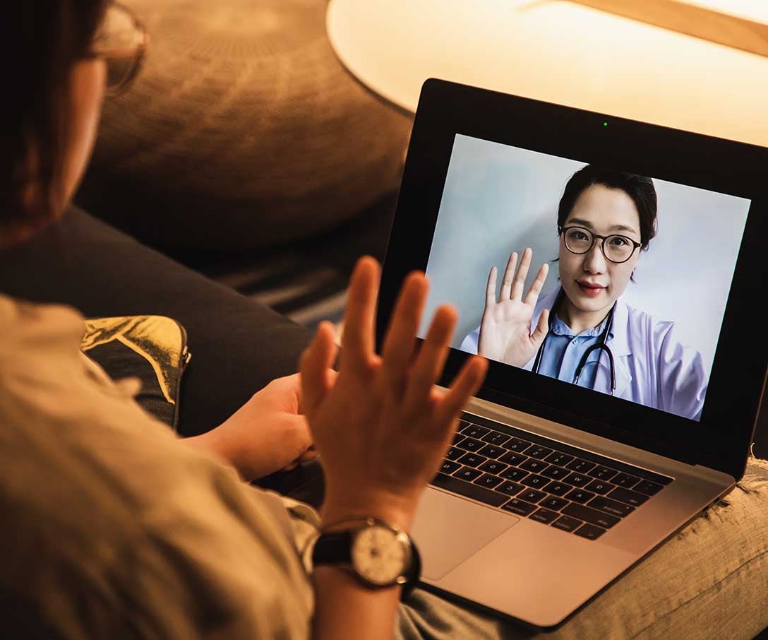 Consulting doctors online using a laptop built by Invesco QQQ holdings.