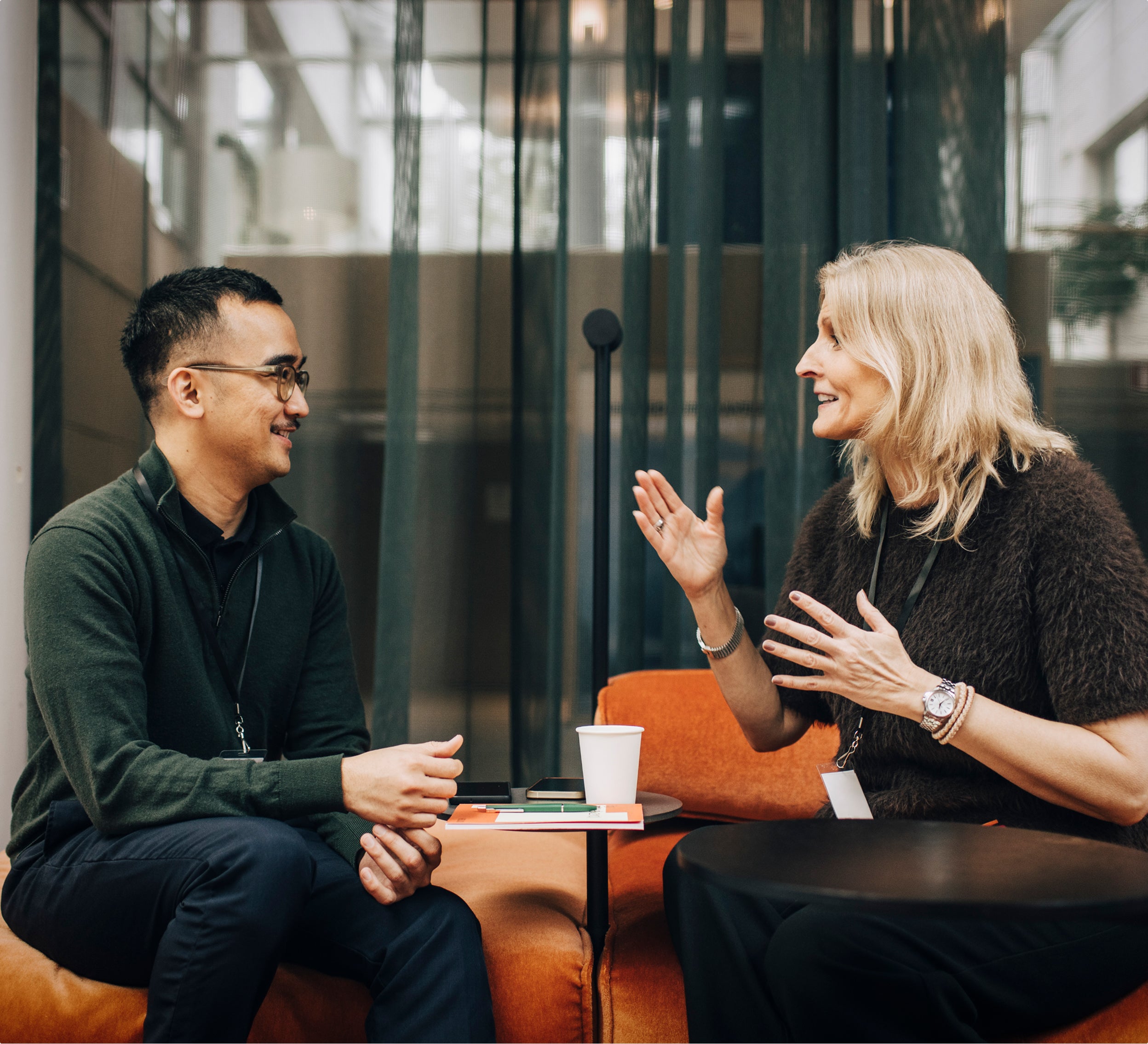 Two people chatting across a small table