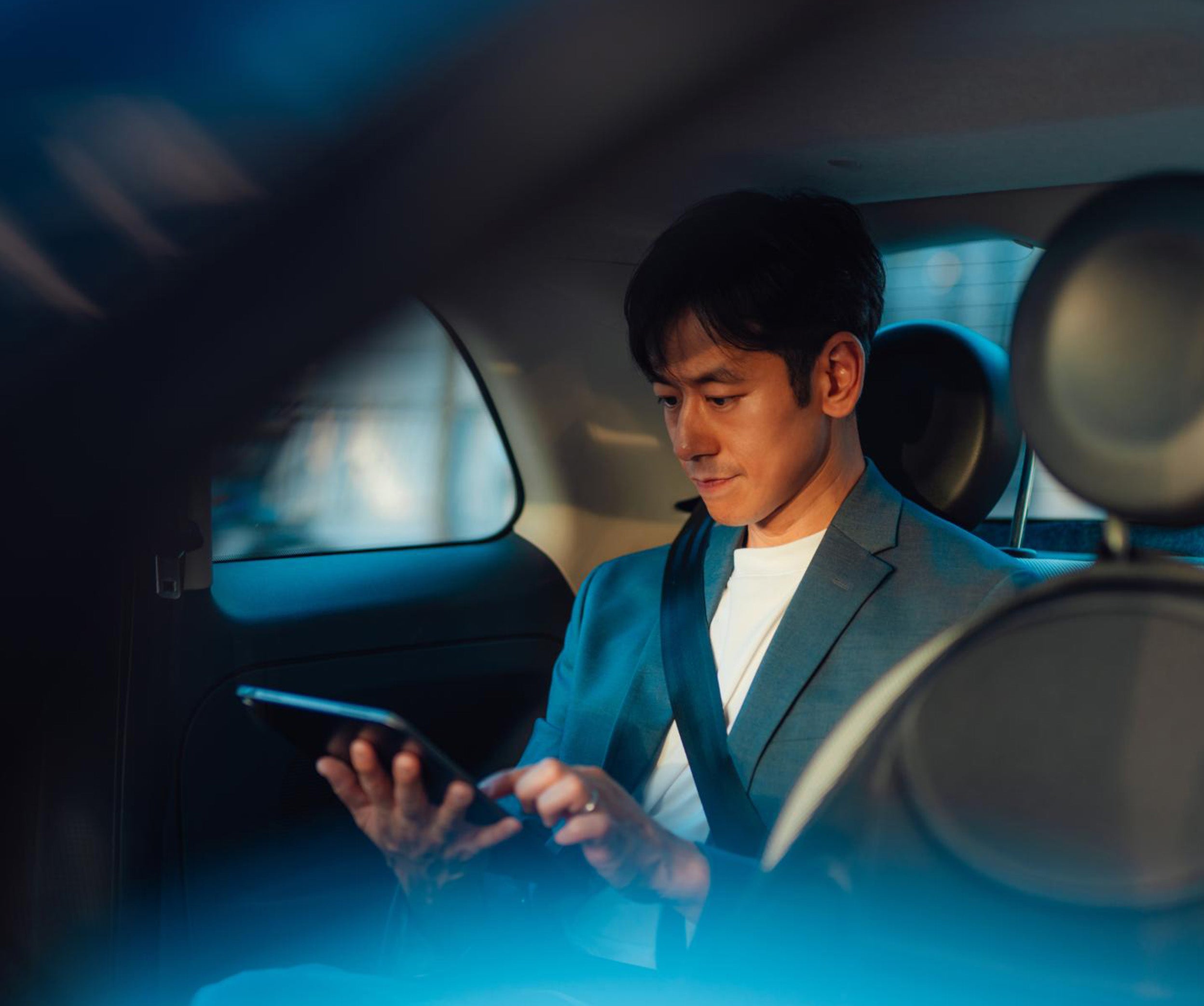Person using a smartphone while seated in a car