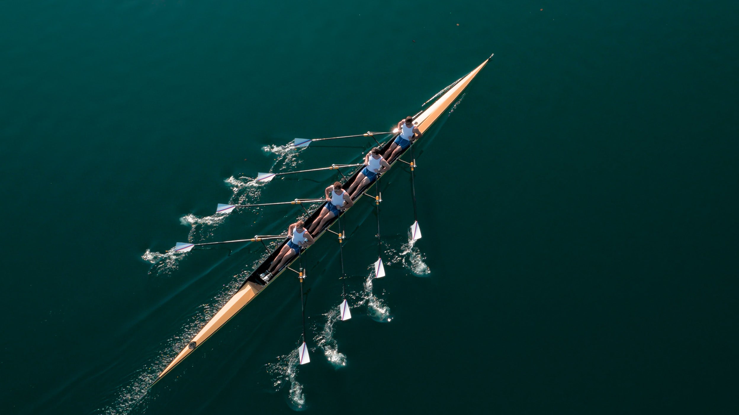 Aerial view of rowing team in action on water