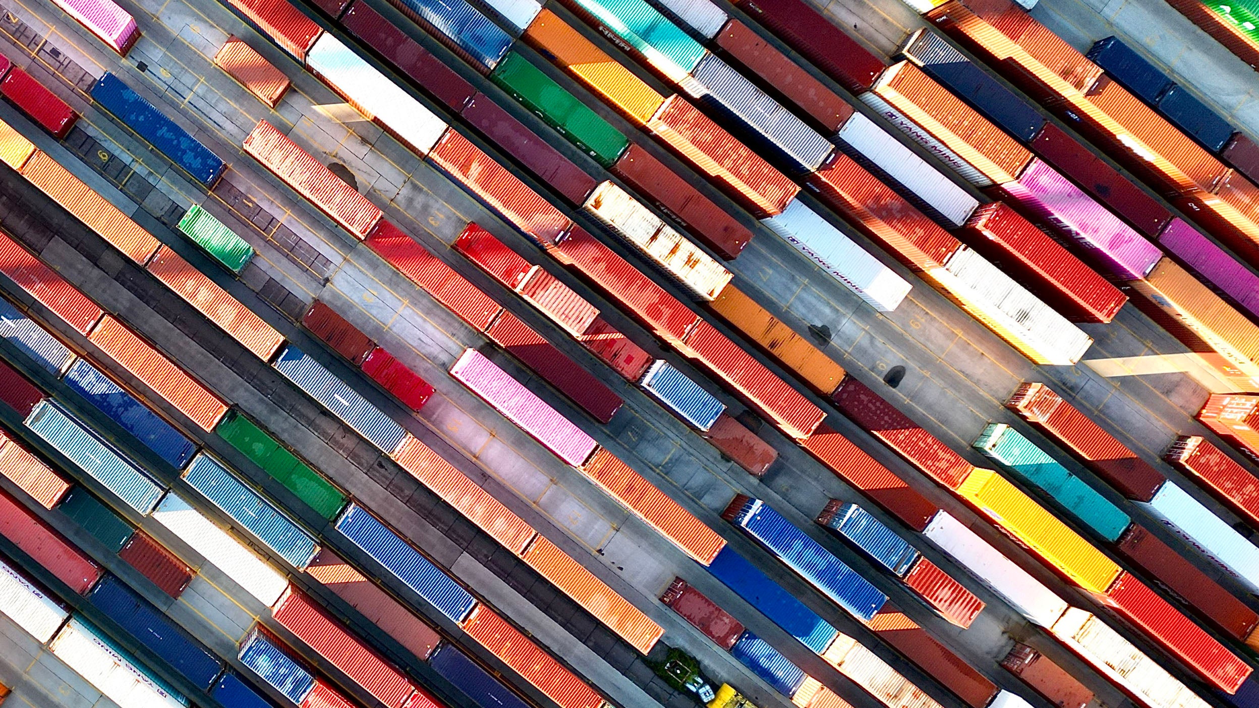 Aerial view of colorful cargo container stacks in shipping port