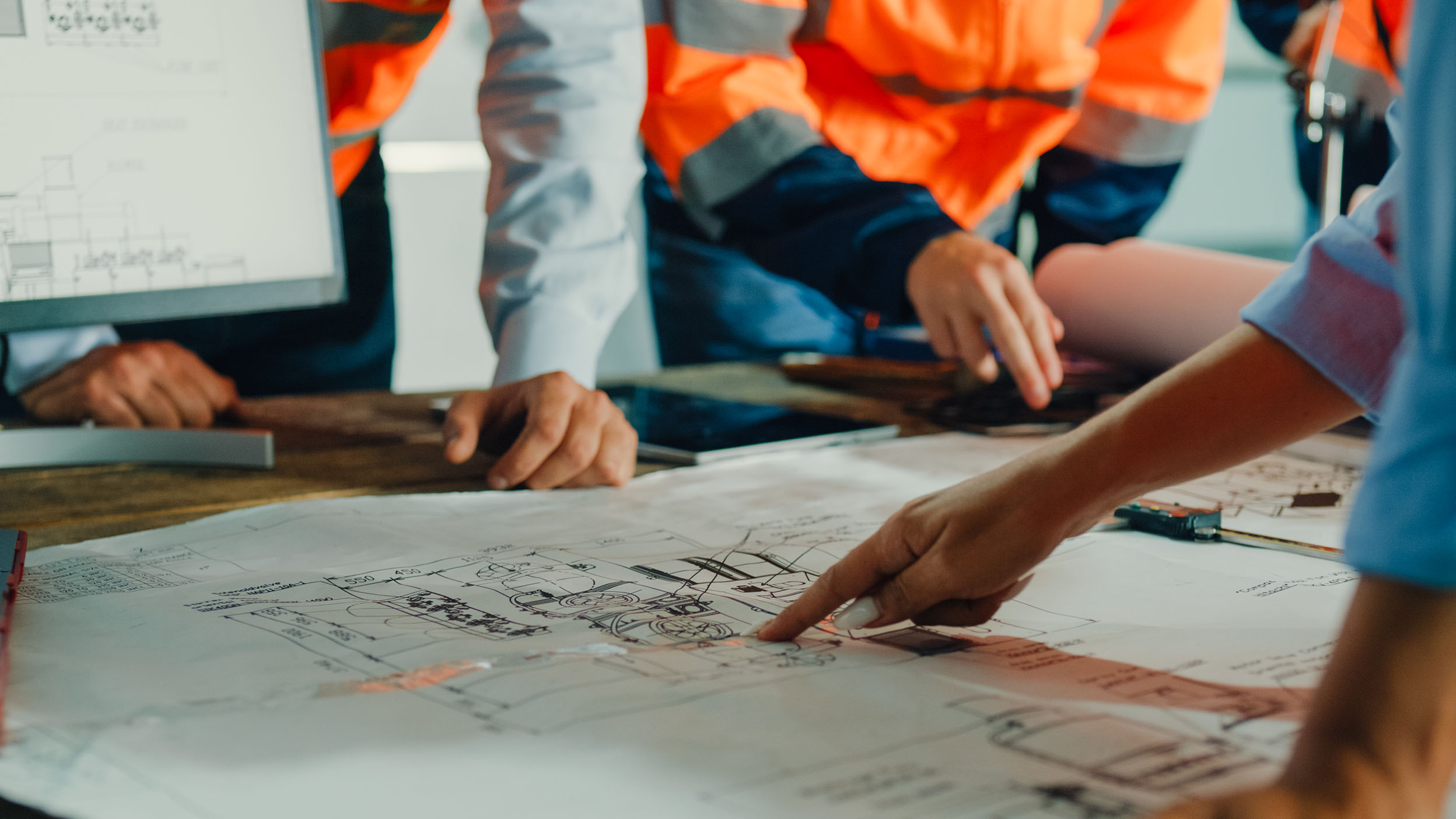 Close-up of Industrial Engineers reviewing blueprints.