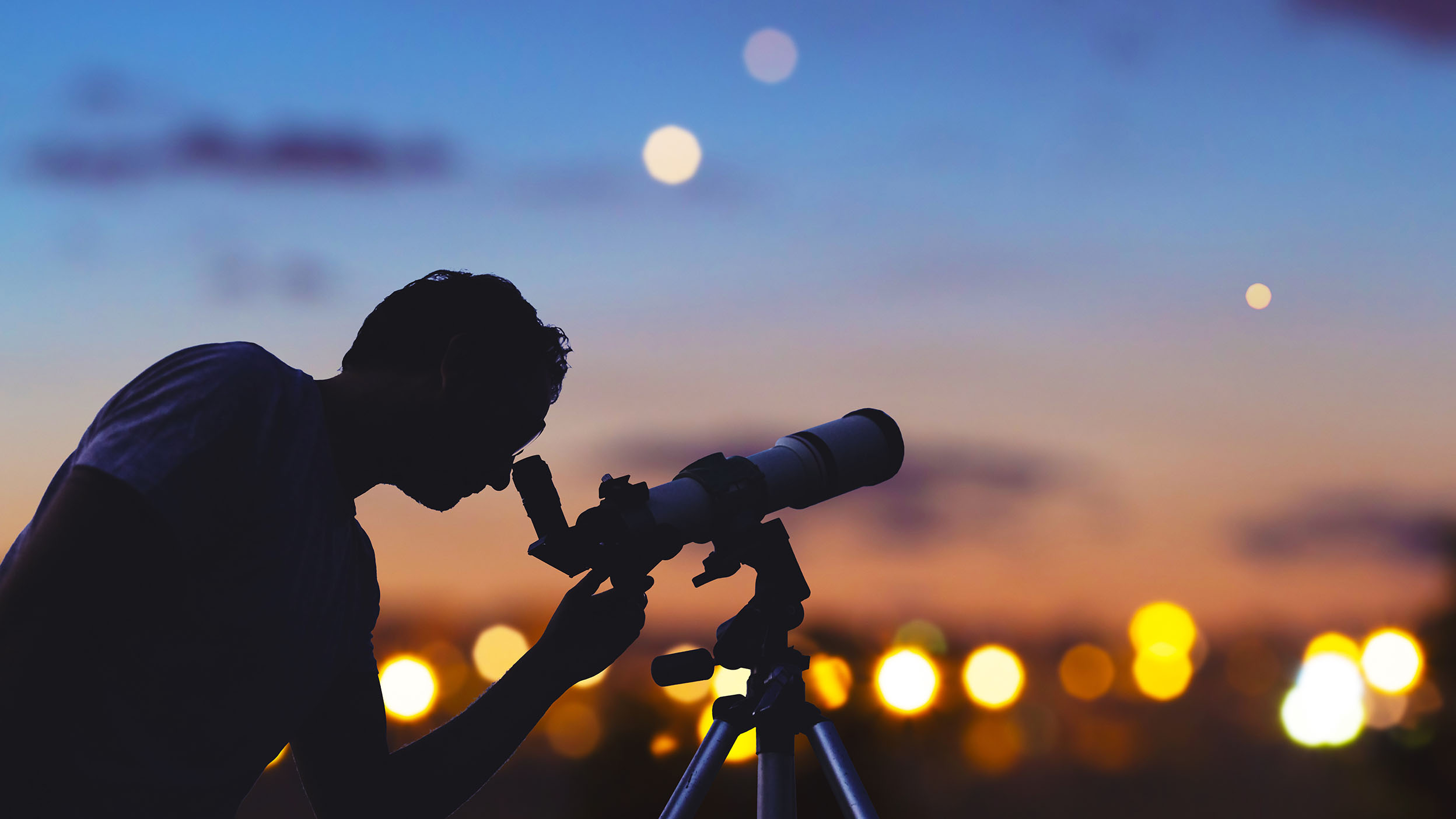 Man looking into a telescope