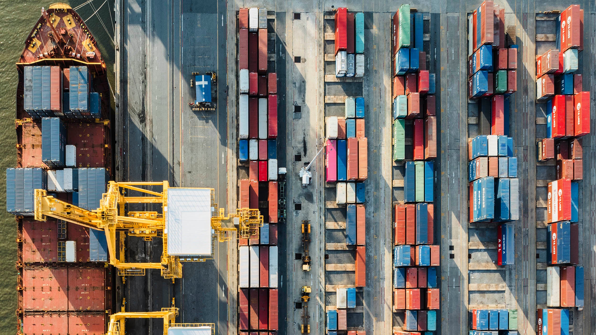 An aerial view of shipping containers in dock.