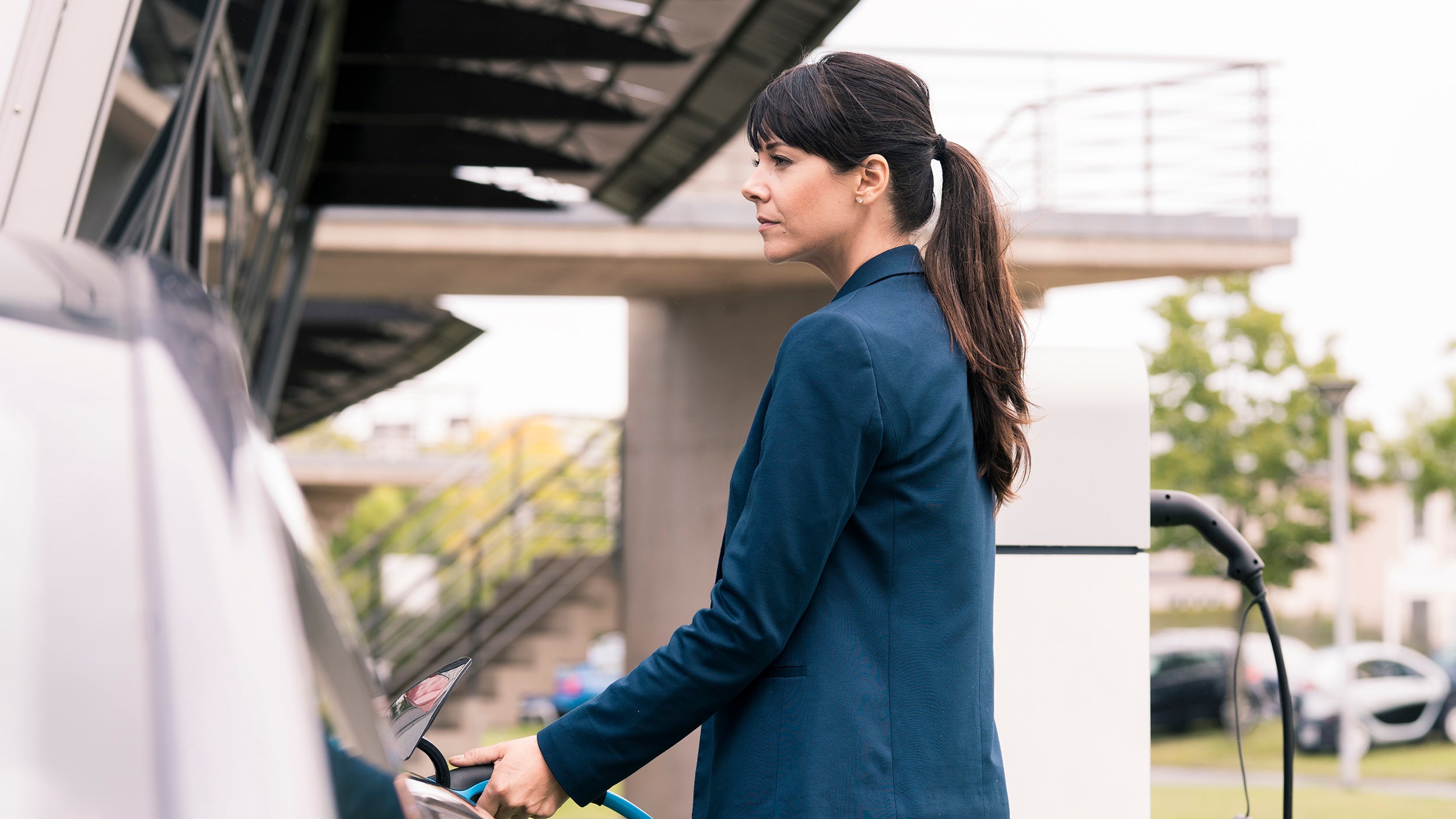 Women recharging the electric vehicle