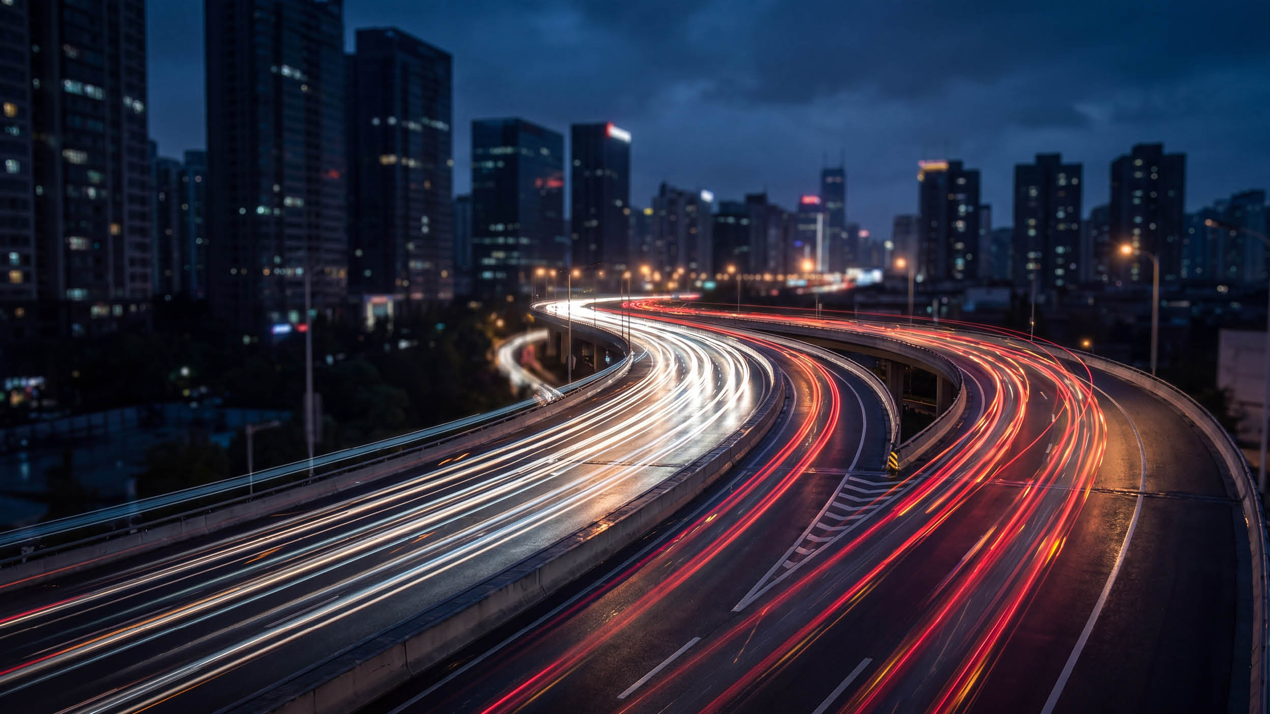 Dynamic city highway at night, long exposure captures vibrant light trails from moving vehicles, urban skyline.