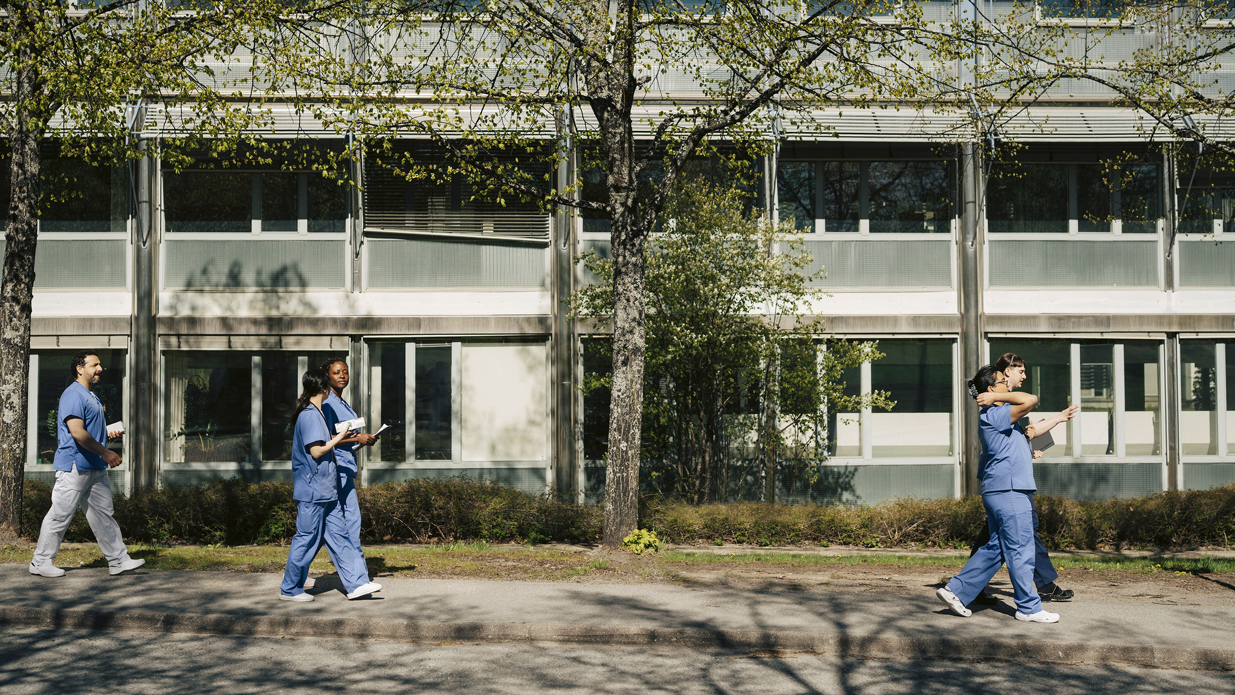 Healthcare workers walking outside a building