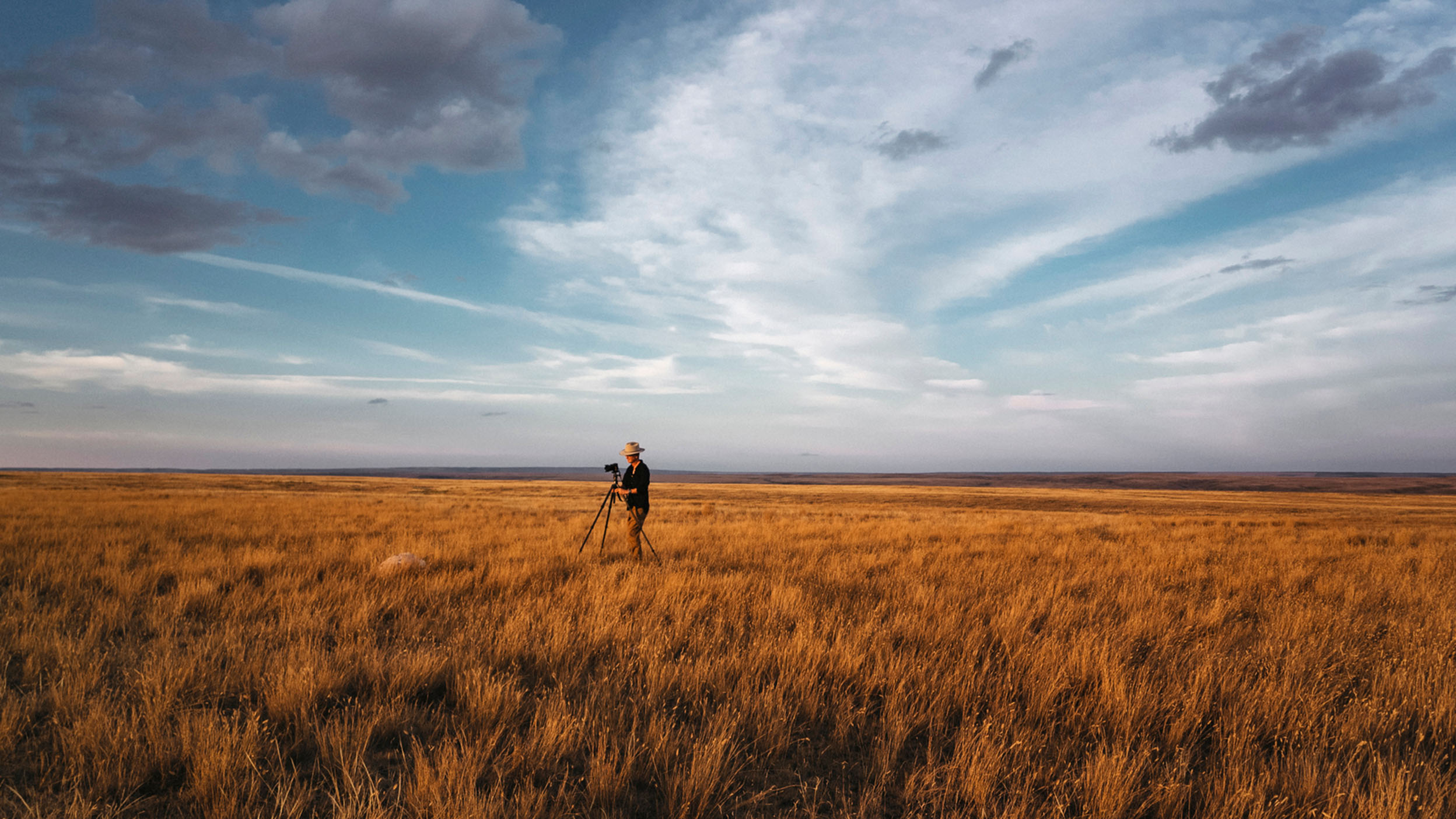 A photographer takes photos in the prairie grasslands