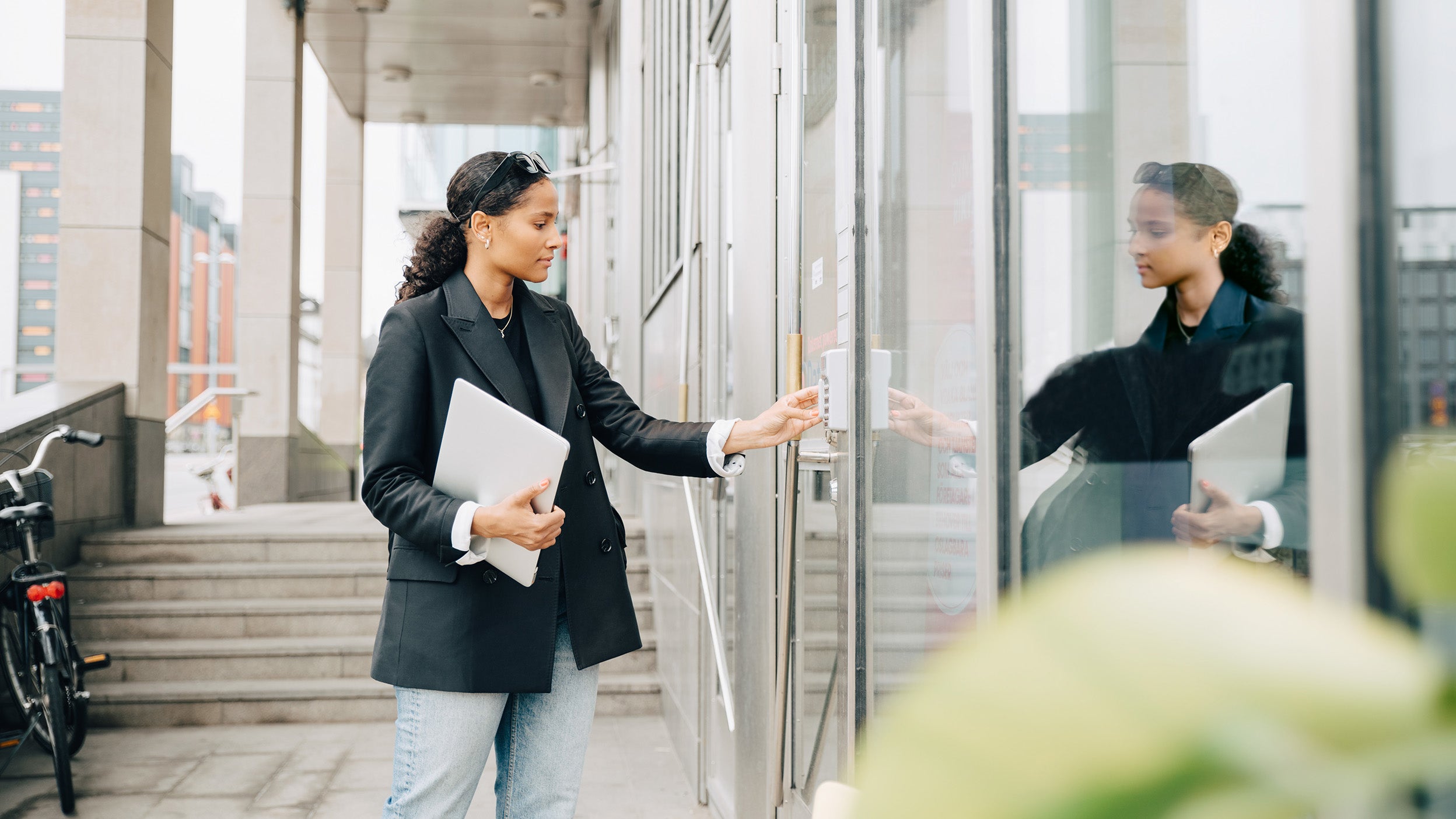 Businesswoman putting keycode to open office door