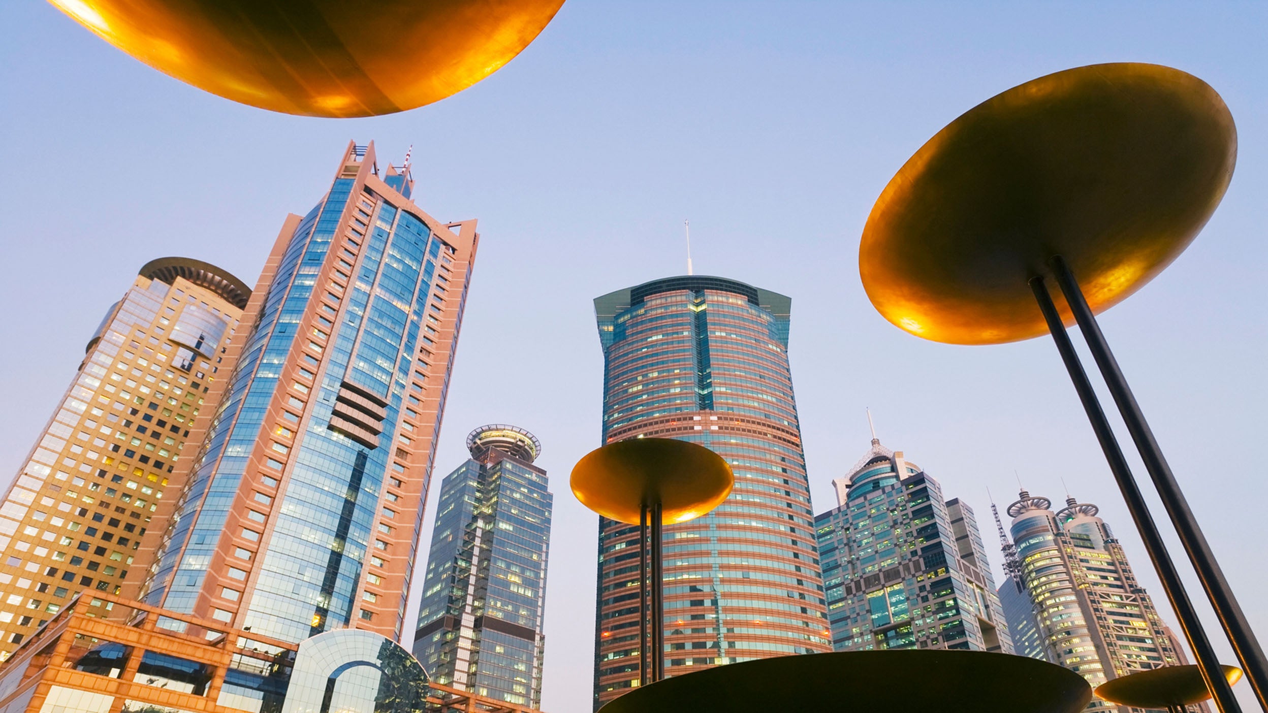 China, Shanghai, Modern skyscrapers illuminated at dusk in Lujiazui financial district of Pudong.