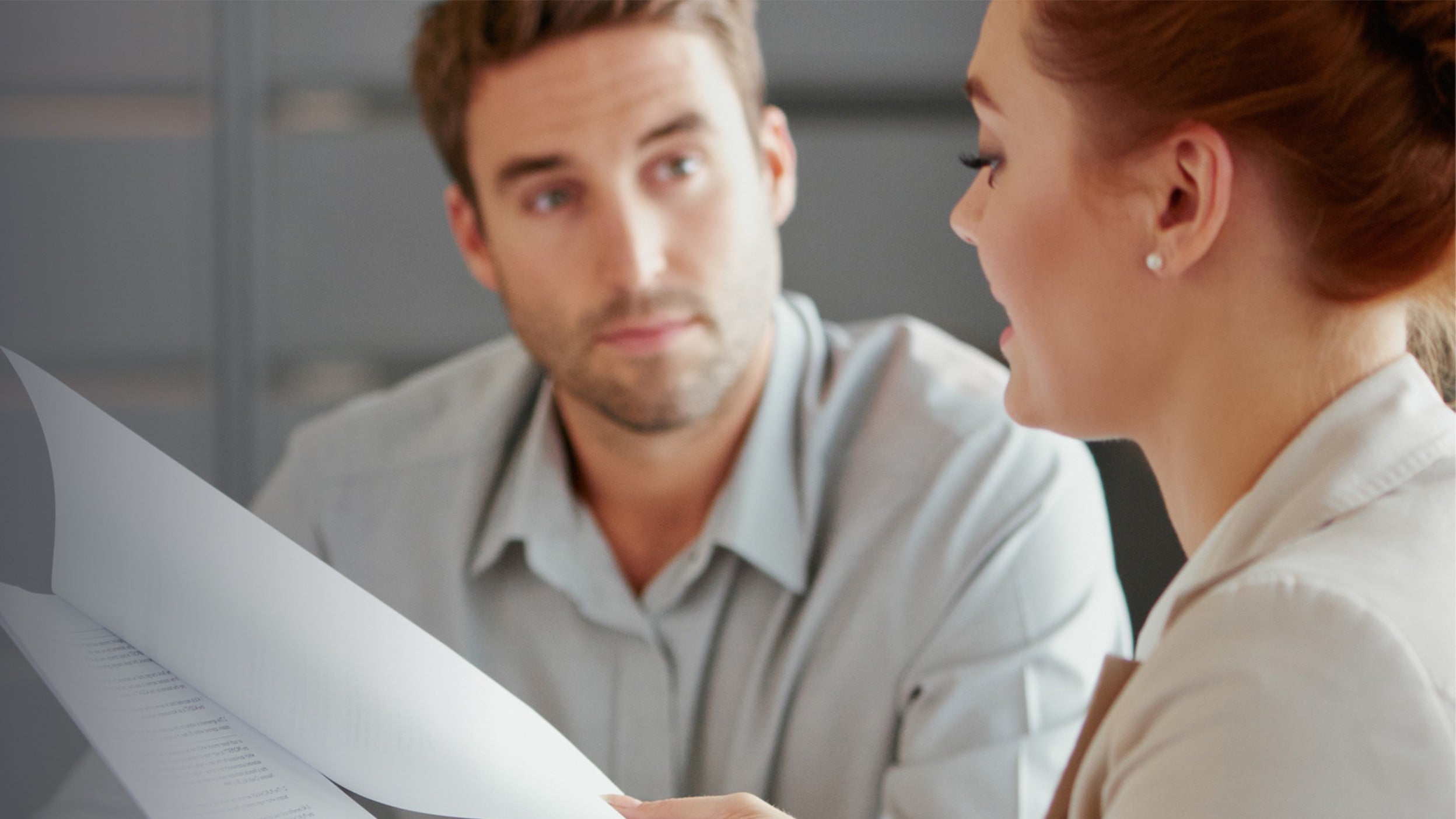 man and woman discussion paperwork