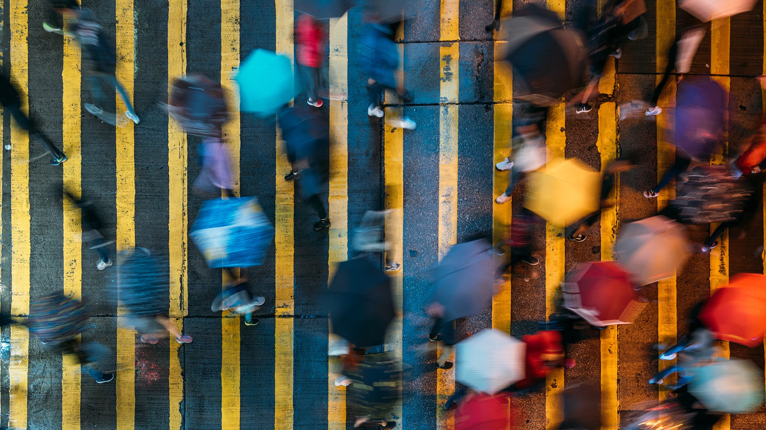 Aerial view of people walking in the rain