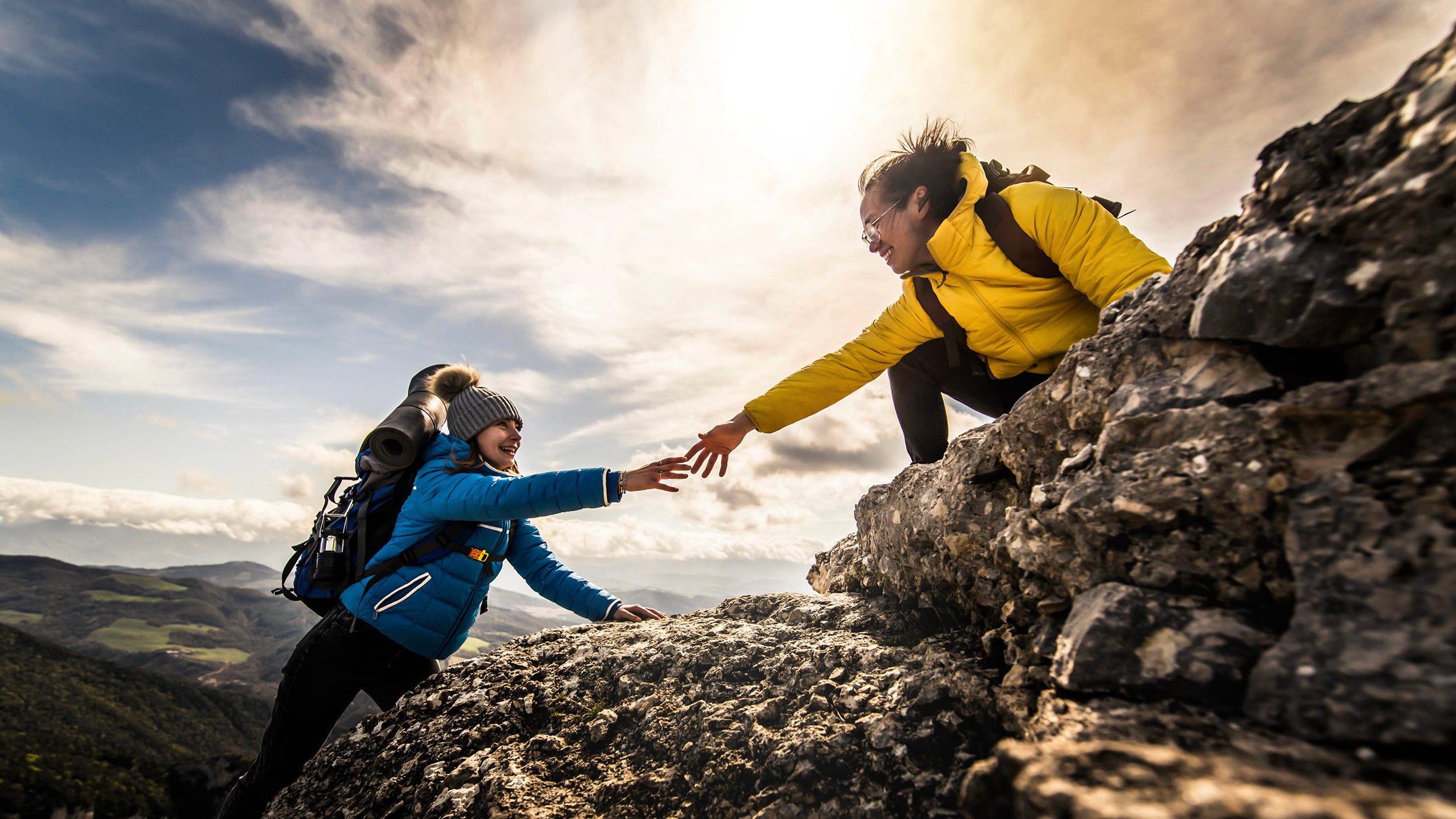 Hiker helping another climber.