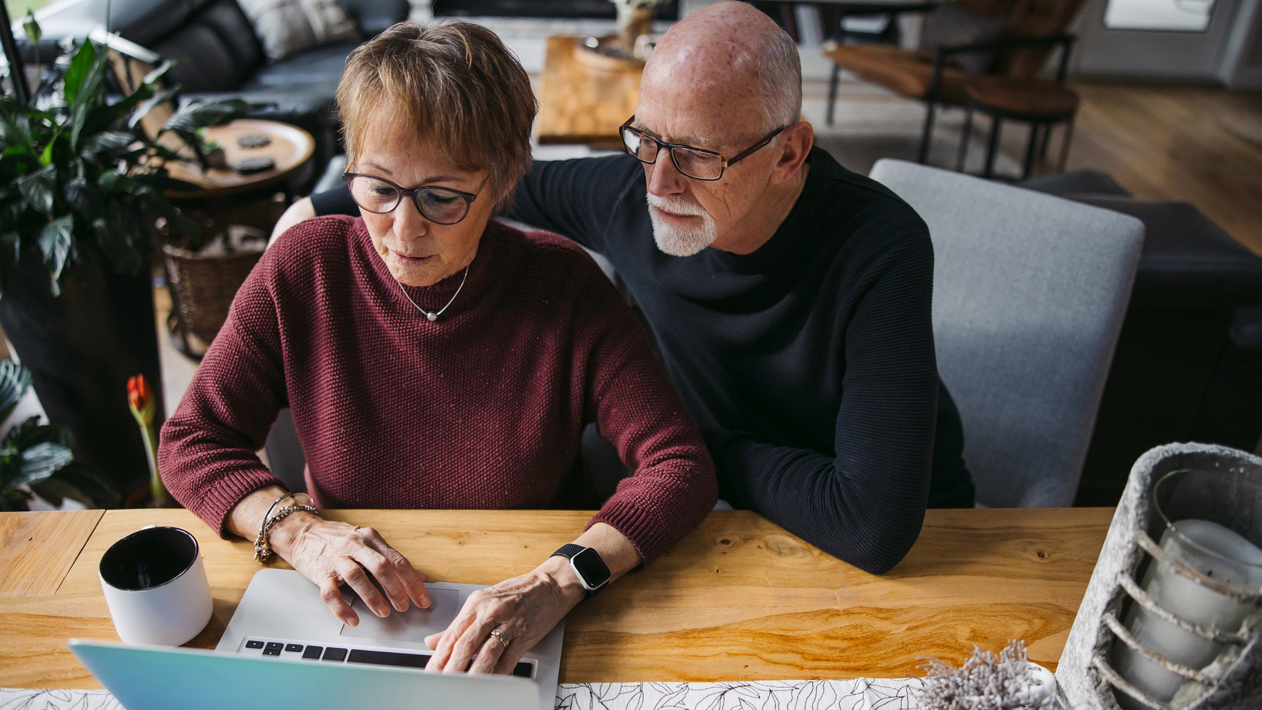Senior couple looking at a laptop