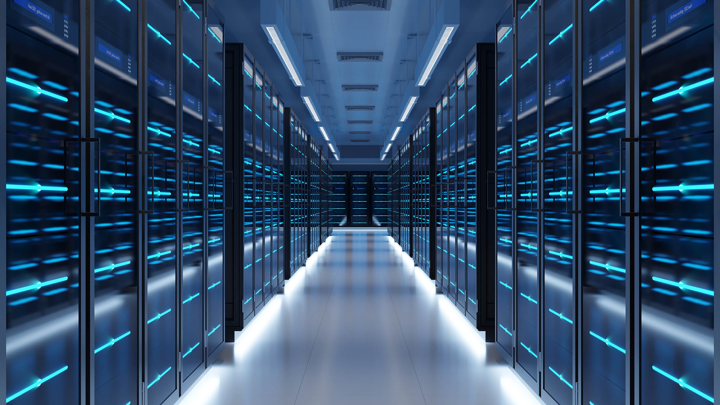  A corridor between rows of illuminated server racks in a data center